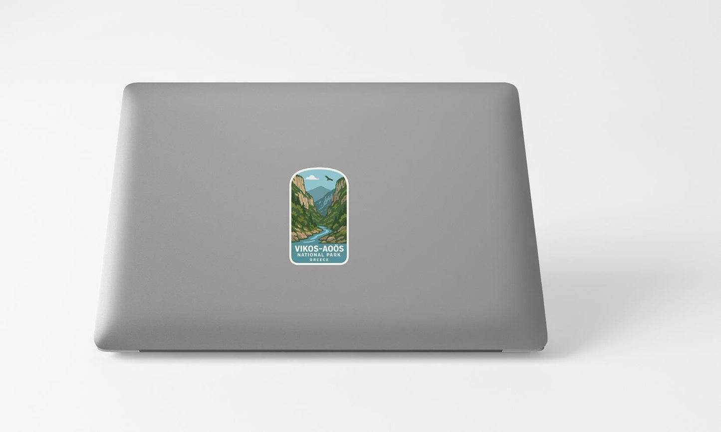 A sticker with a mountain landscape on a laptop.