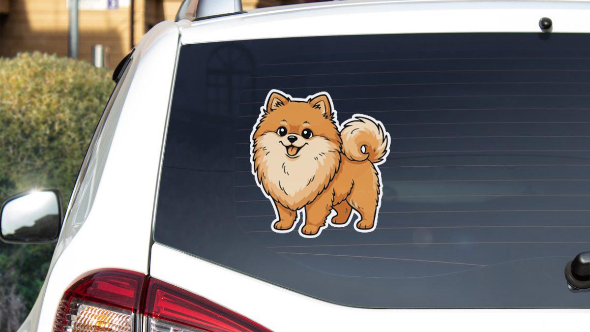 A sticker of a small brown dog is displayed on the rear window of a white car.