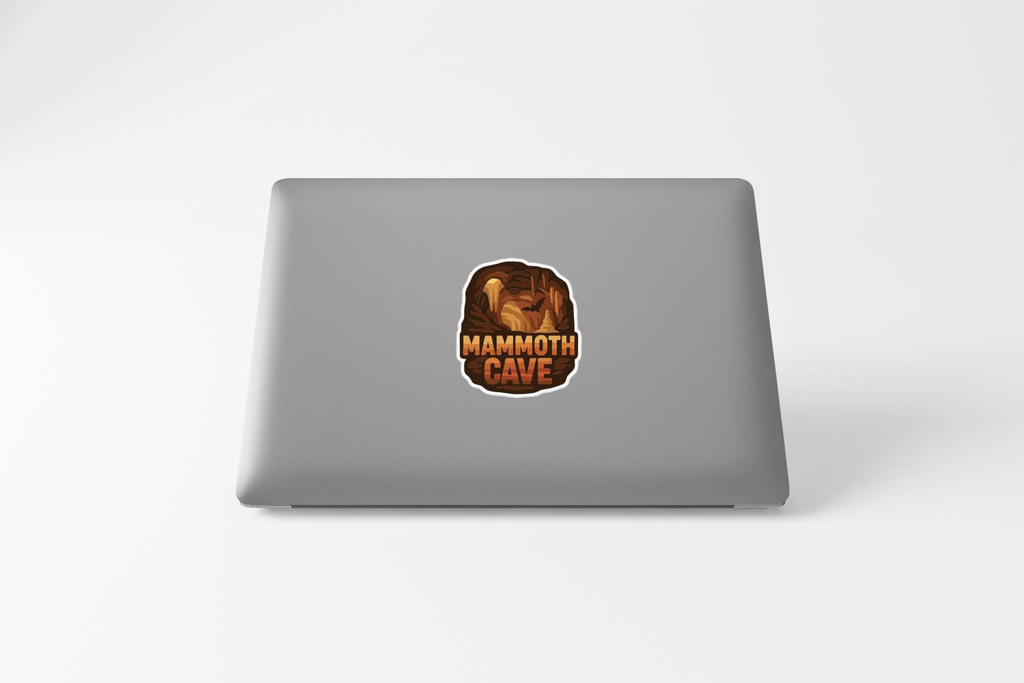 a sticker with the text "MAMMOTH CAVE" on the back of a laptop.