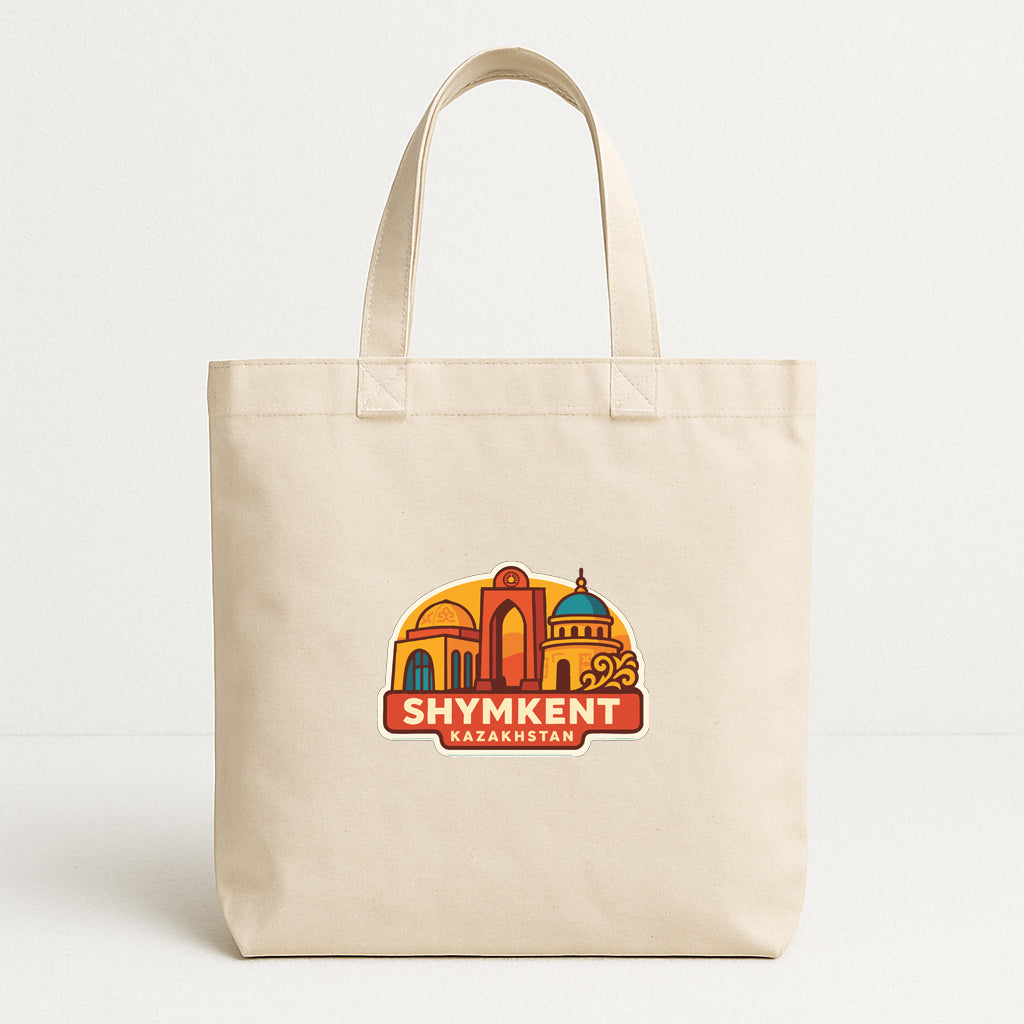 A beige tote bag with a colorful graphic of a city skyline and the text "SHYMKENT KAZKHSTAN" printed on it.