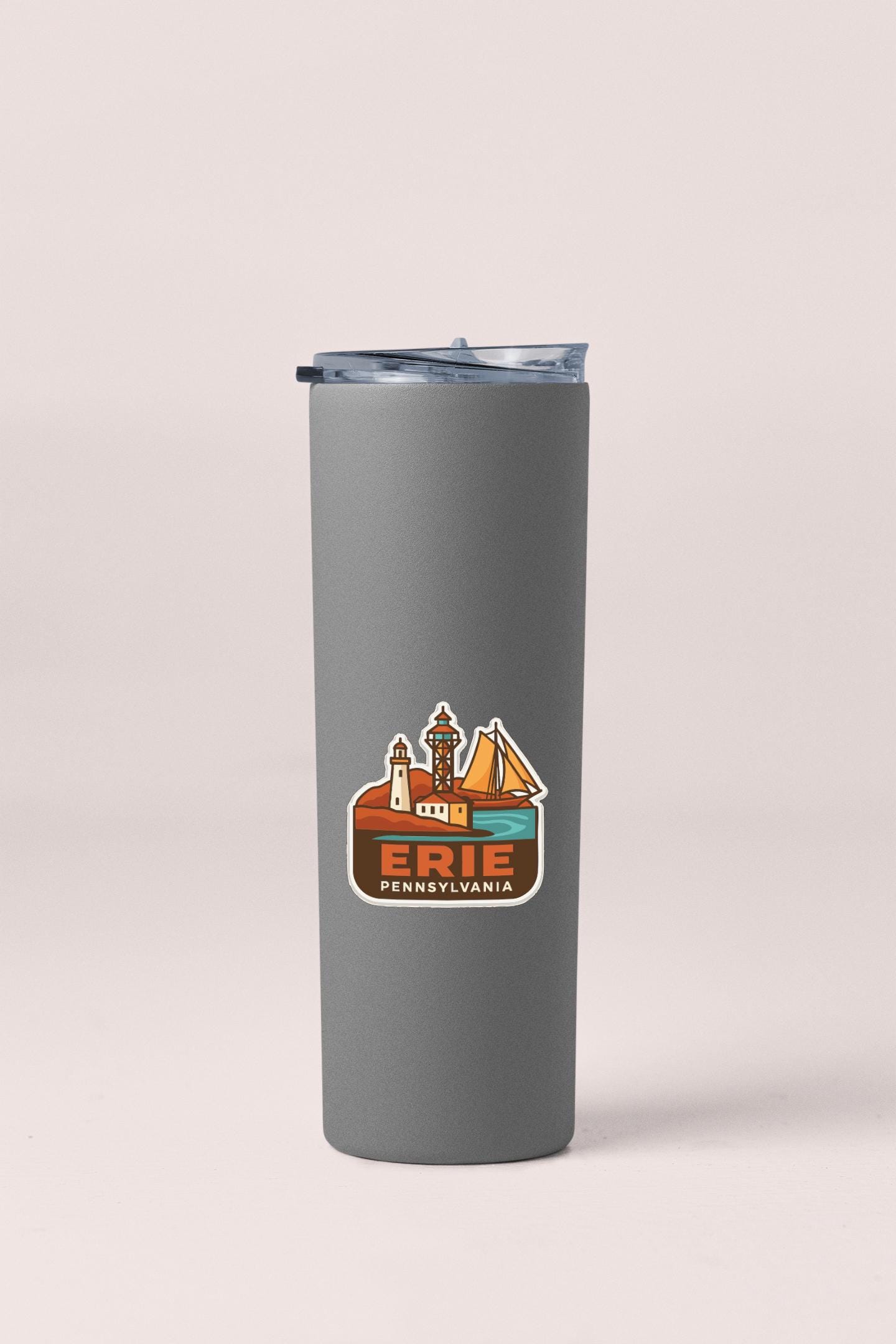 A gray insulated tumbler with a sticker depicting a scenic view of Erie, Pennsylvania.