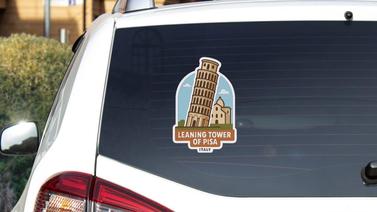 A sticker on the rear window of a car depicting the Leaning Tower of Pisa, a famous landmark in Italy.
