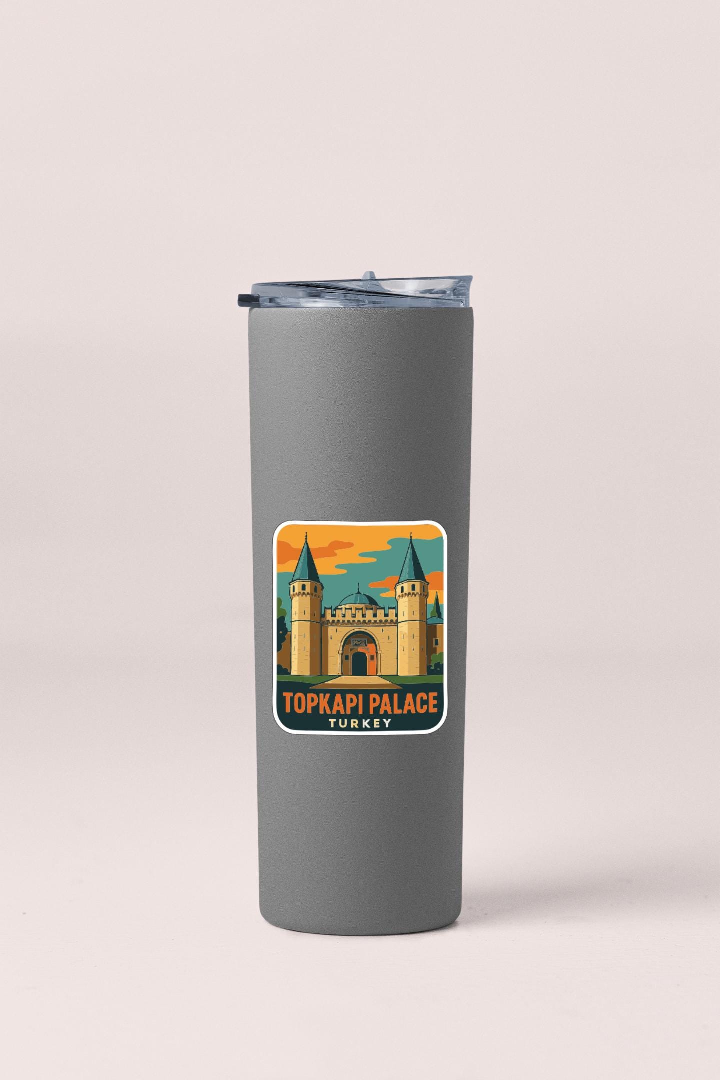 A gray insulated tumbler with a sticker depicting the Topkapi Palace in Turkey.