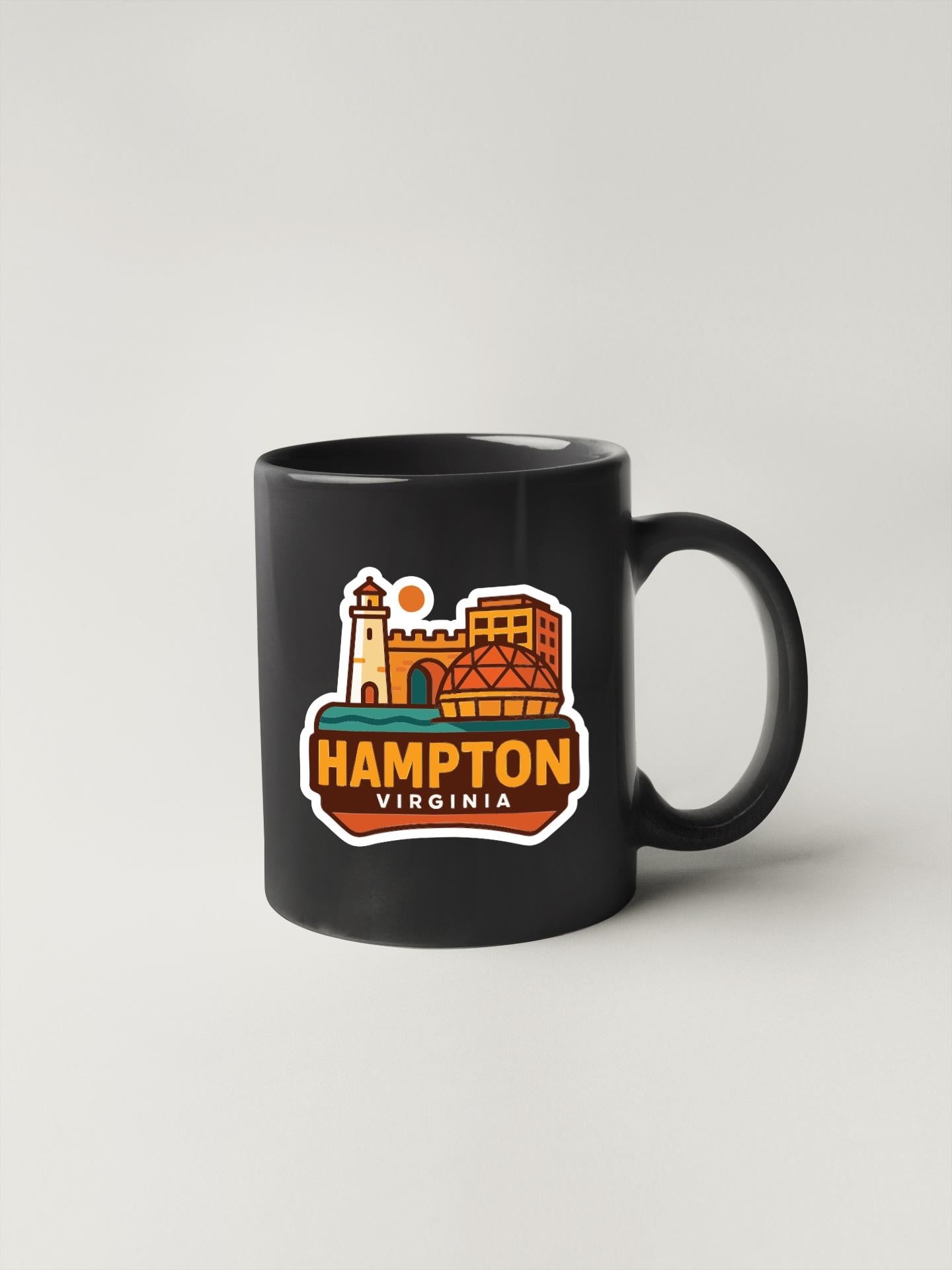A black coffee mug with a colorful graphic depicting the city of Hampton, Virginia.