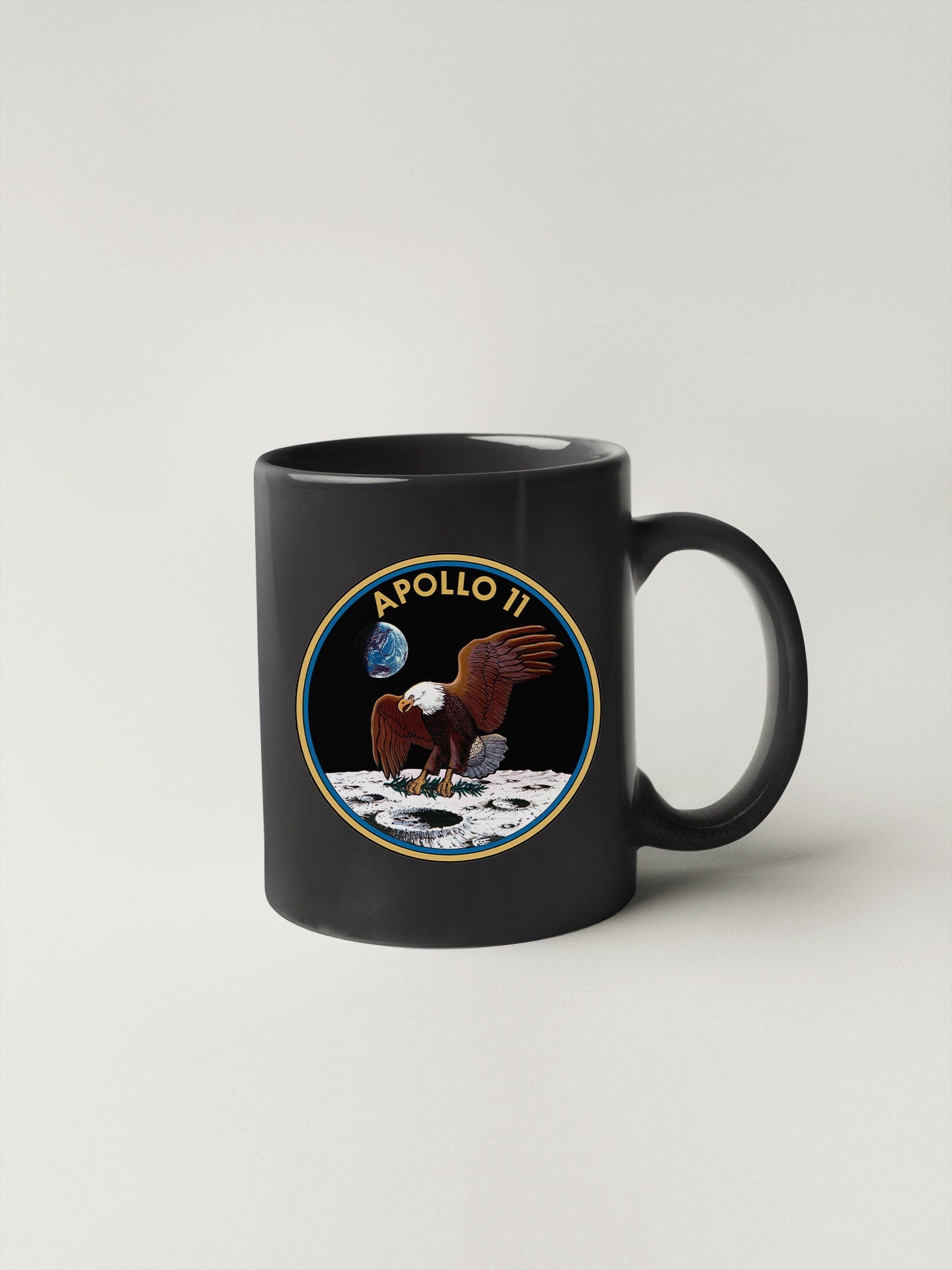 a black coffee mug with a picture of an eagle on it