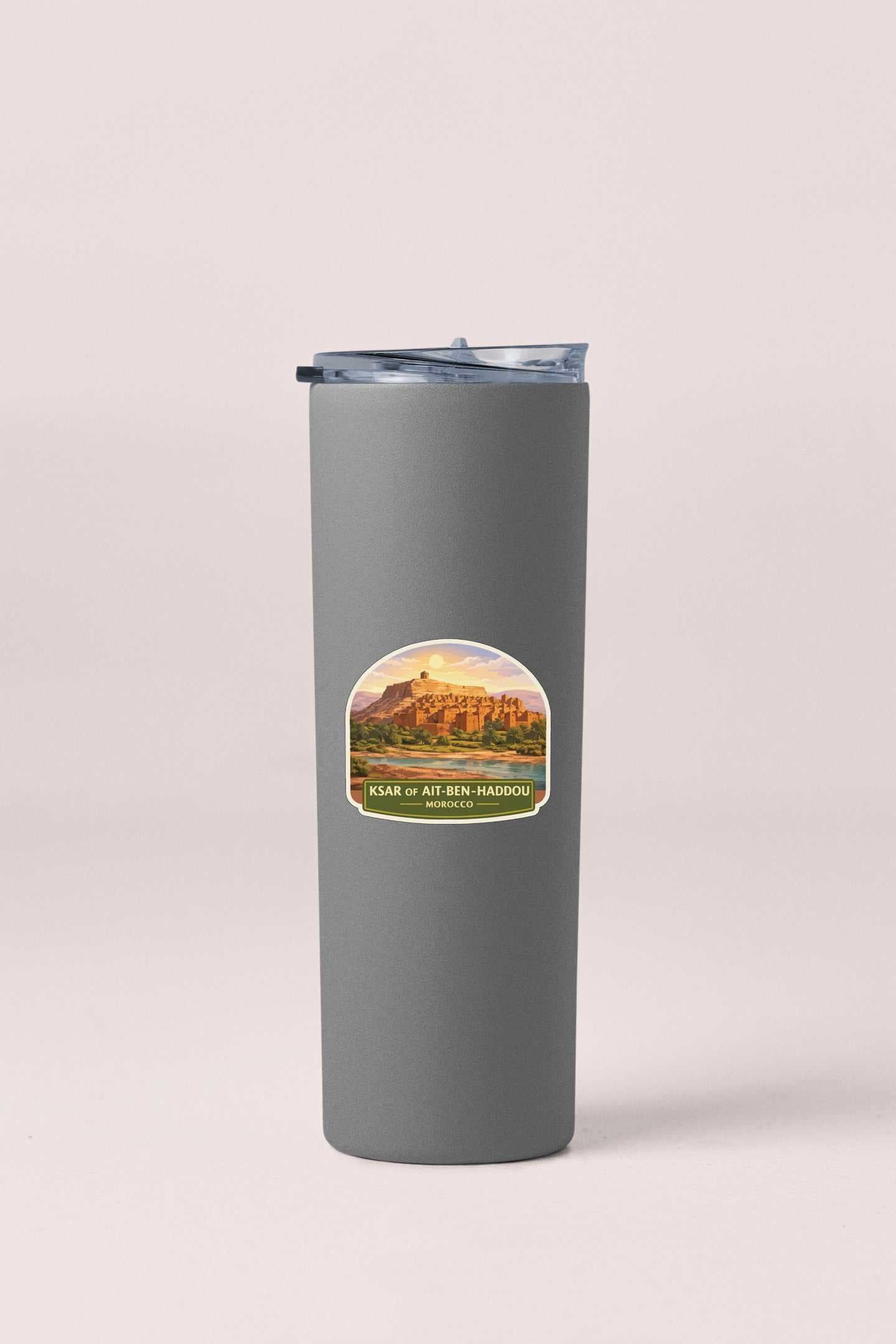 A gray cylindrical thermos with a label featuring a desert landscape and text.
