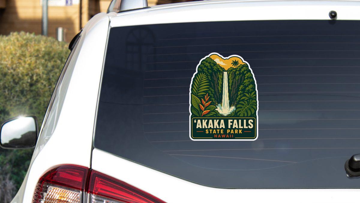 A sticker on the rear window of a white vehicle, depicting a waterfall surrounded by lush greenery.