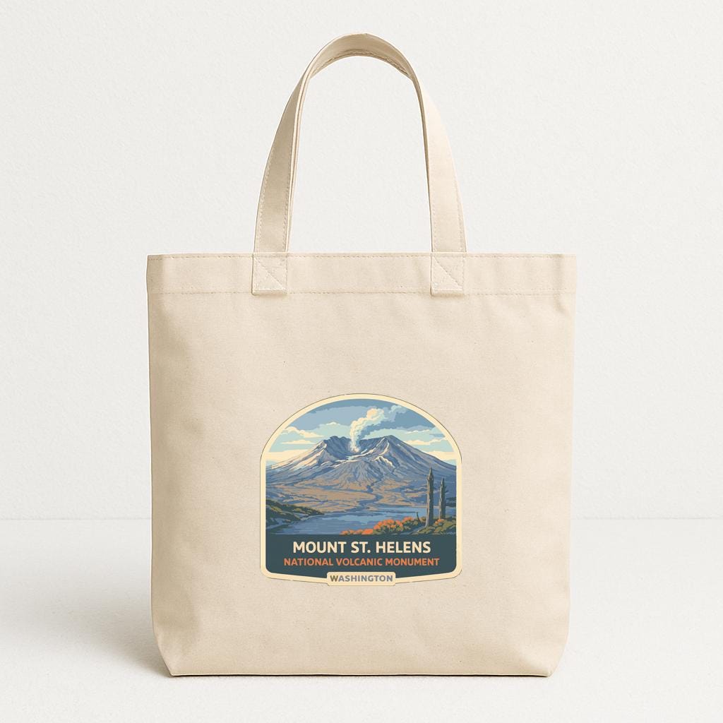 A beige tote bag with a printed design depicting Mount St. Helens, a famous landmark in Washington.