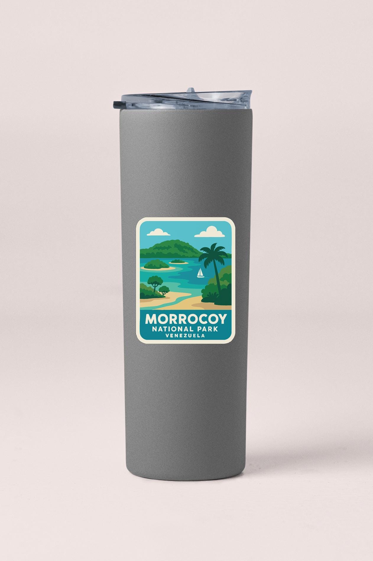 A gray insulated tumbler with a label that features a tropical beach scene and the text "Morrocoy National Park, Venezuela".