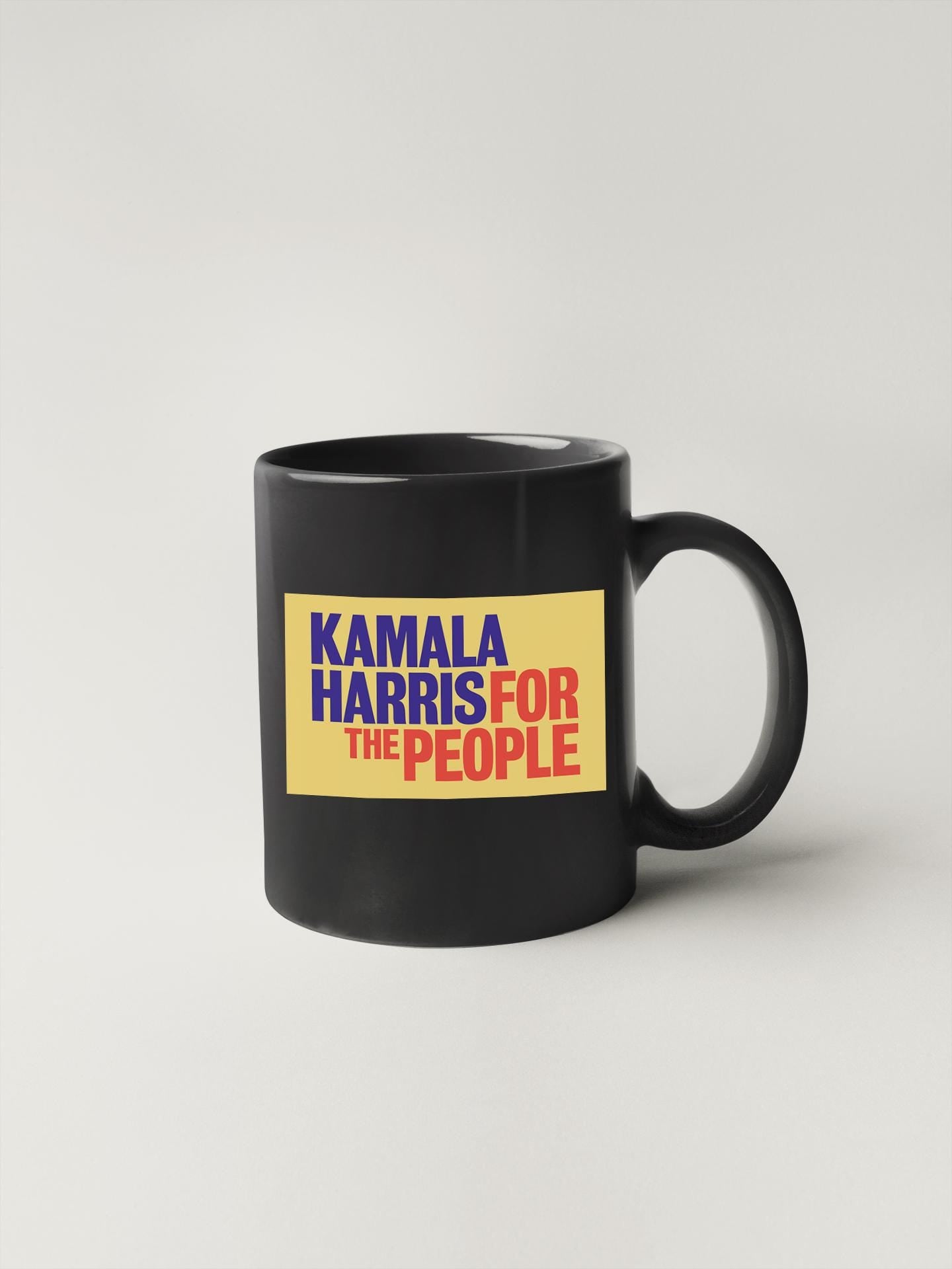 a black coffee mug with the words karma harris for the people on it