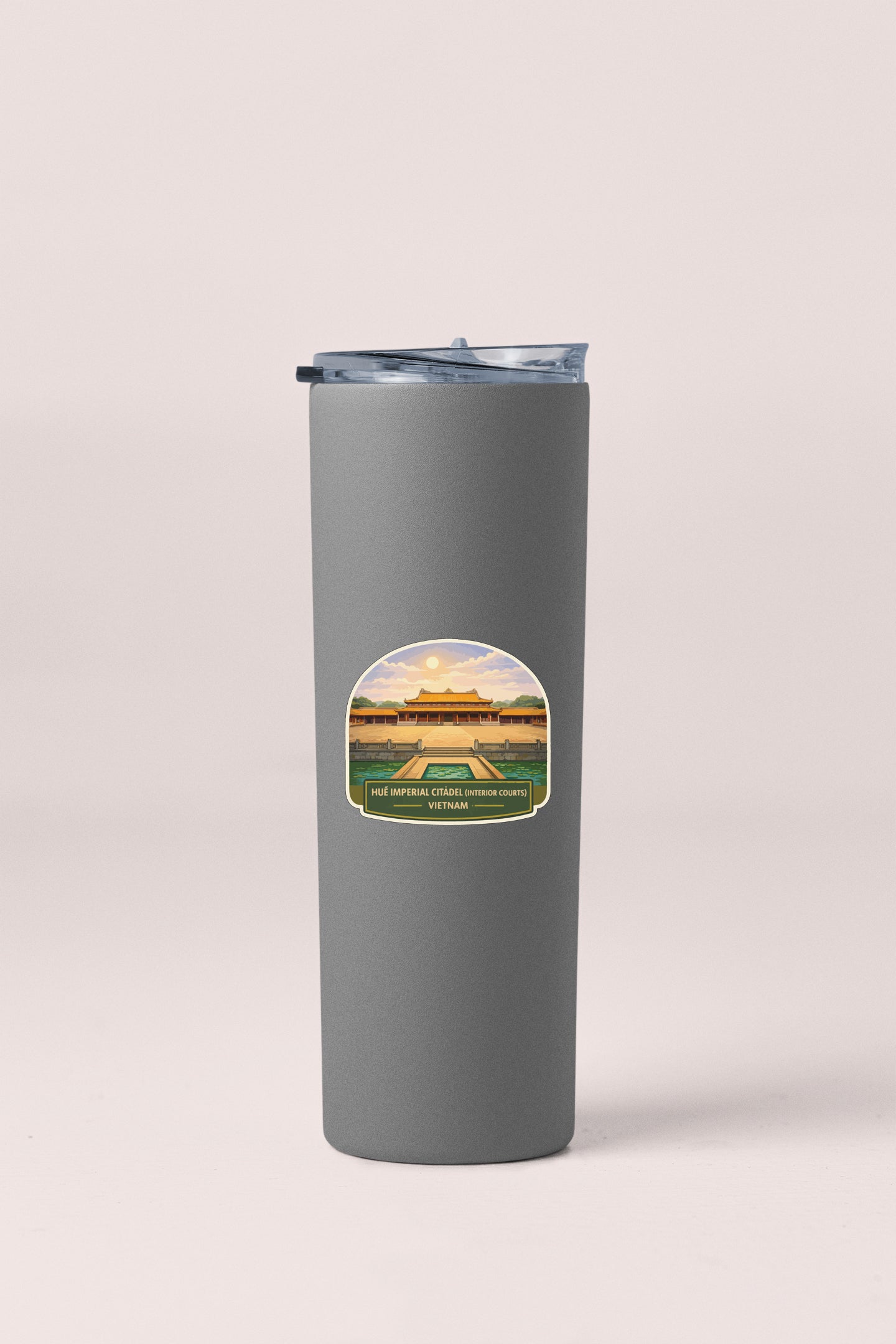 A gray insulated tumbler with a sticker depicting a building and text.