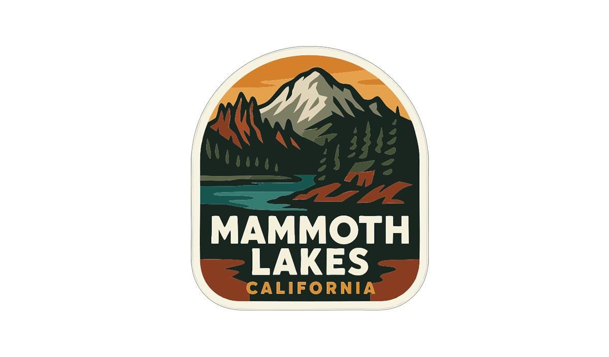 a sticker or emblem with a mountain landscape and a lake, representing the location of Mammoth Lakes, California.