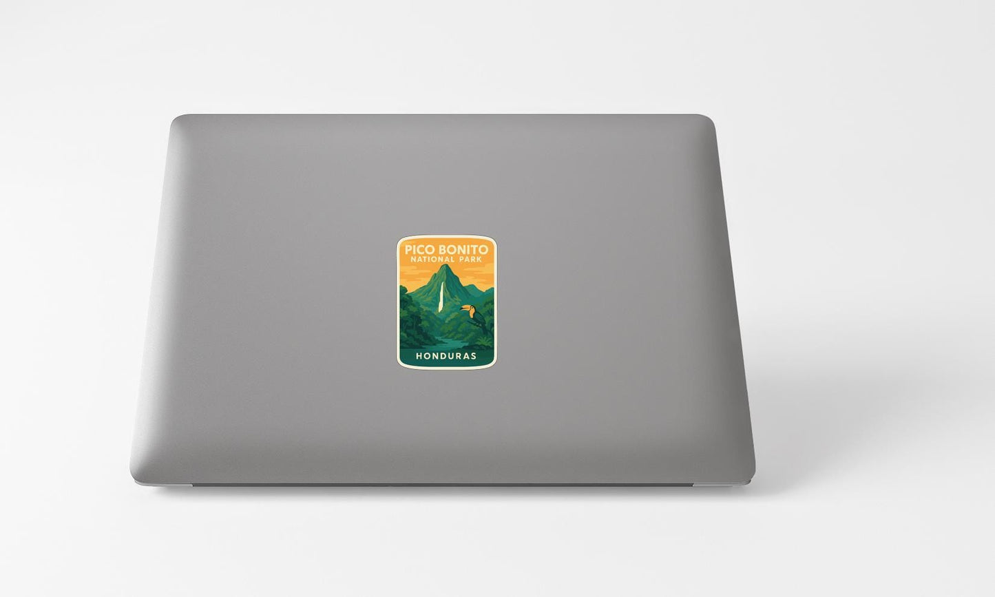 A sticker with a mountain landscape and text on a laptop.