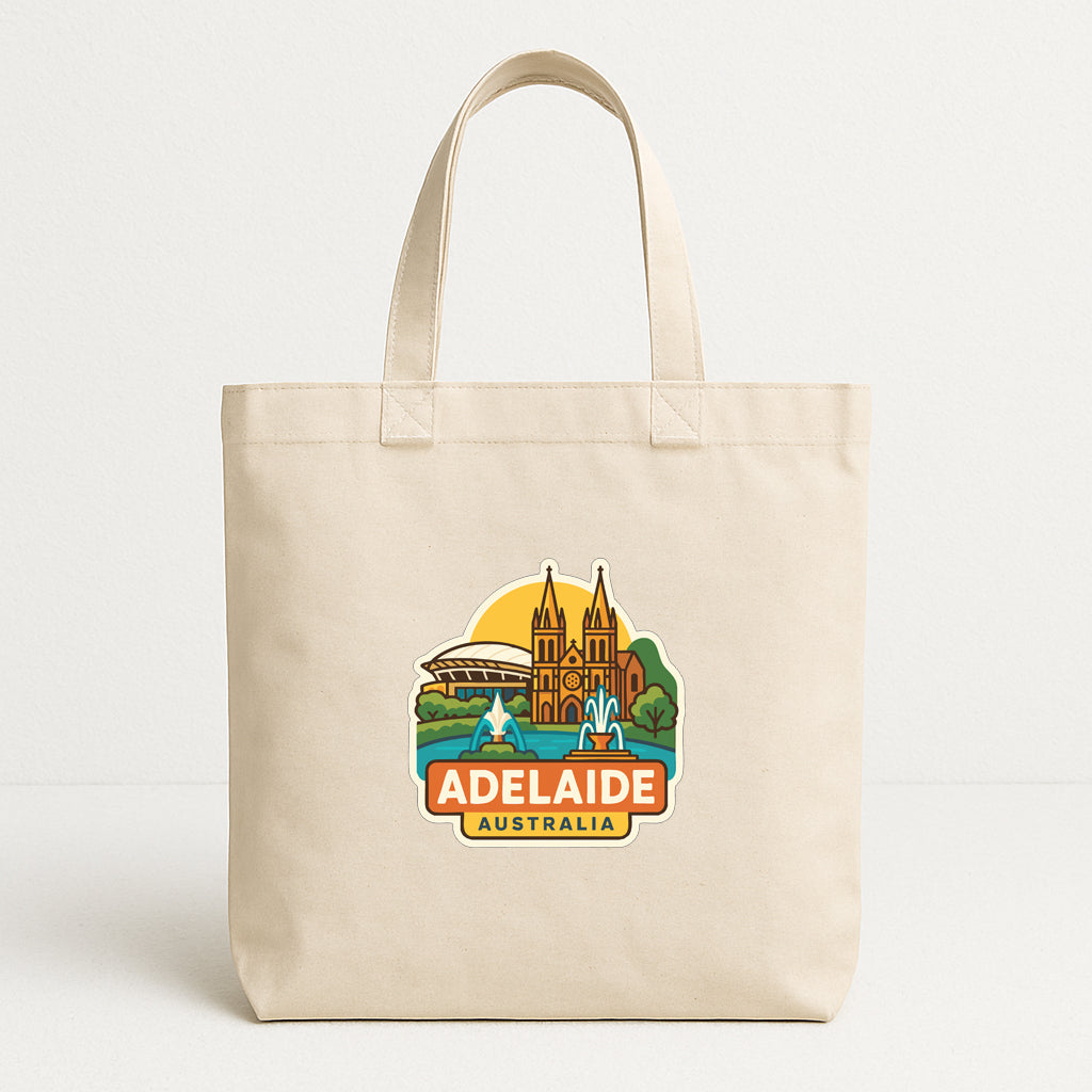 A beige tote bag with a graphic design featuring landmarks and text related to the city of Adelaide, Australia.
