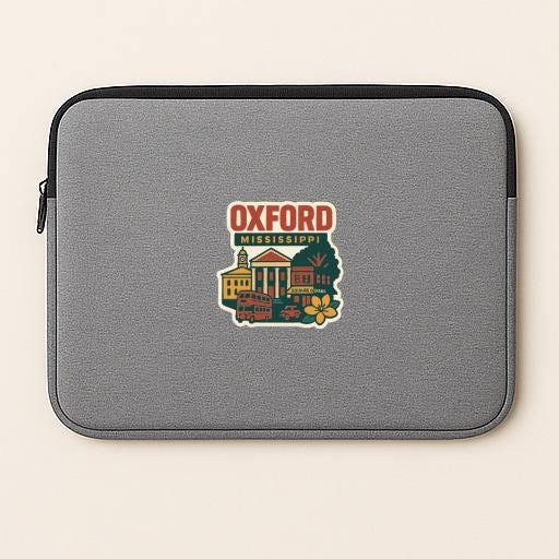 A gray laptop sleeve with a colorful sticker depicting a cityscape and the text "Oxford Mississippi".