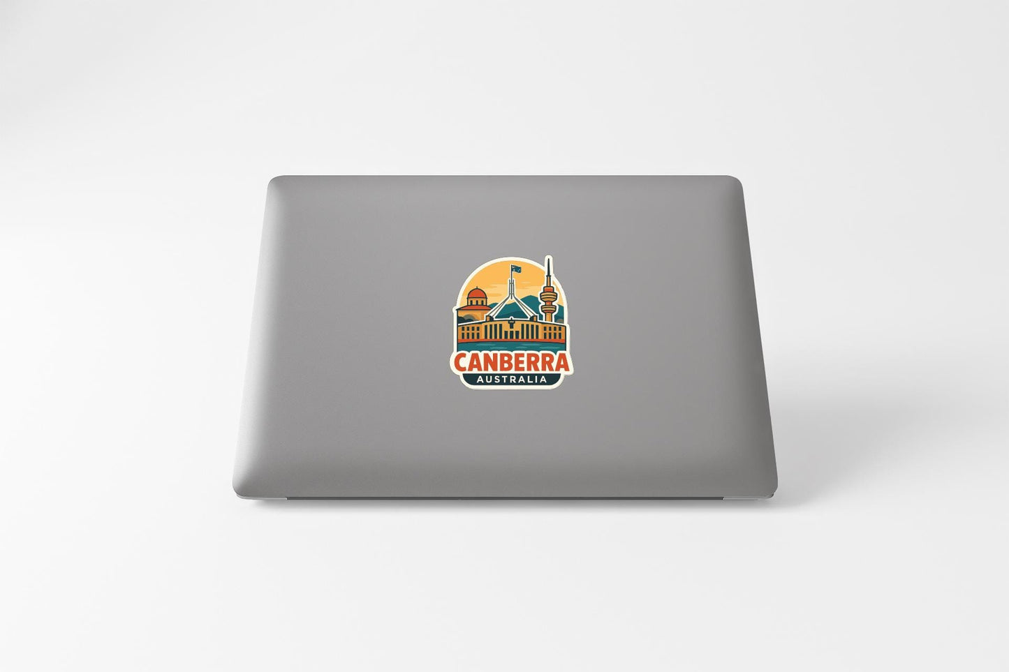 a sticker of the city of Canberra, Australia, on the back of a laptop computer.