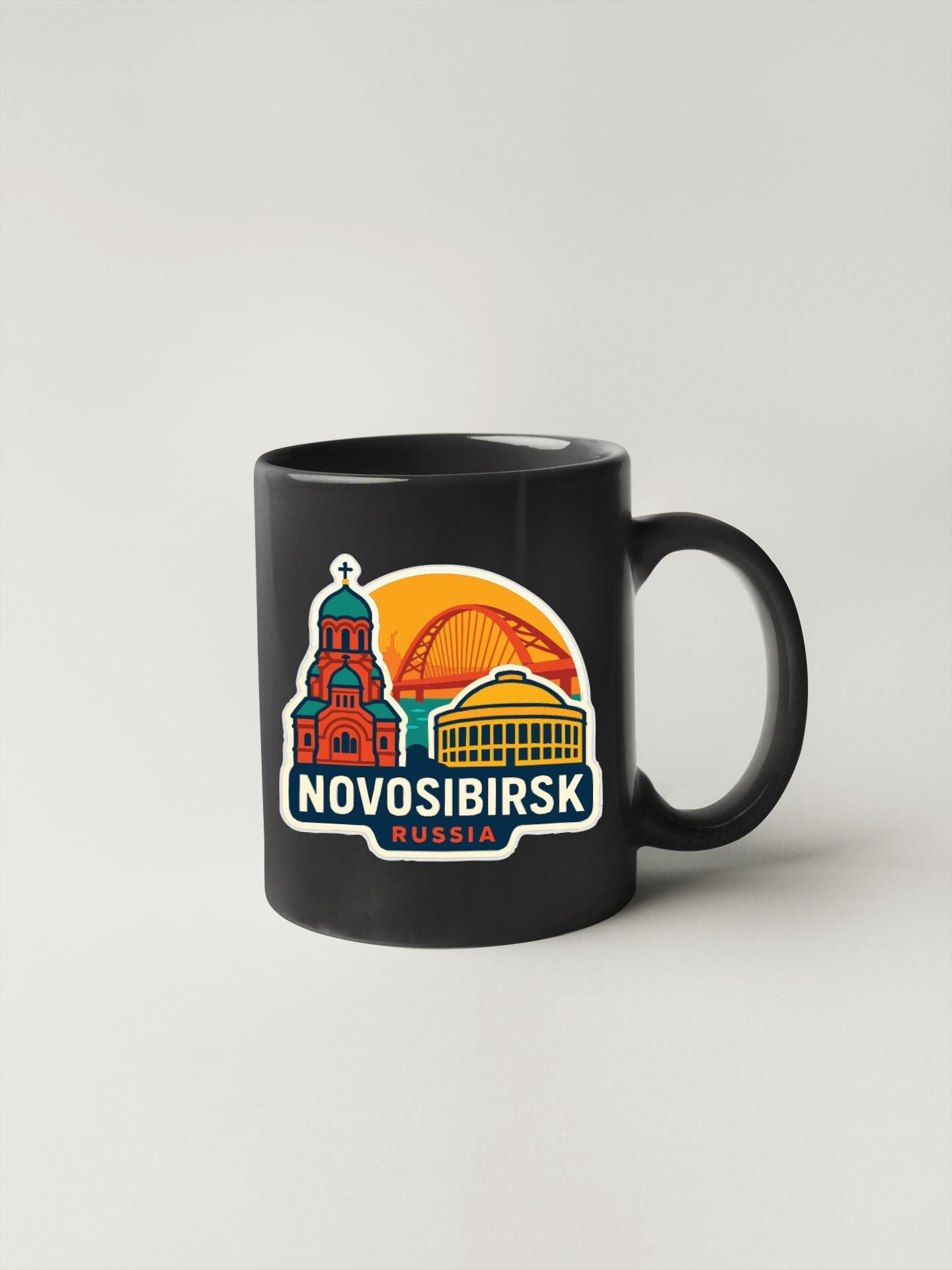 A black coffee mug with a colorful graphic depicting the Novosibirsk, Russia landmark.