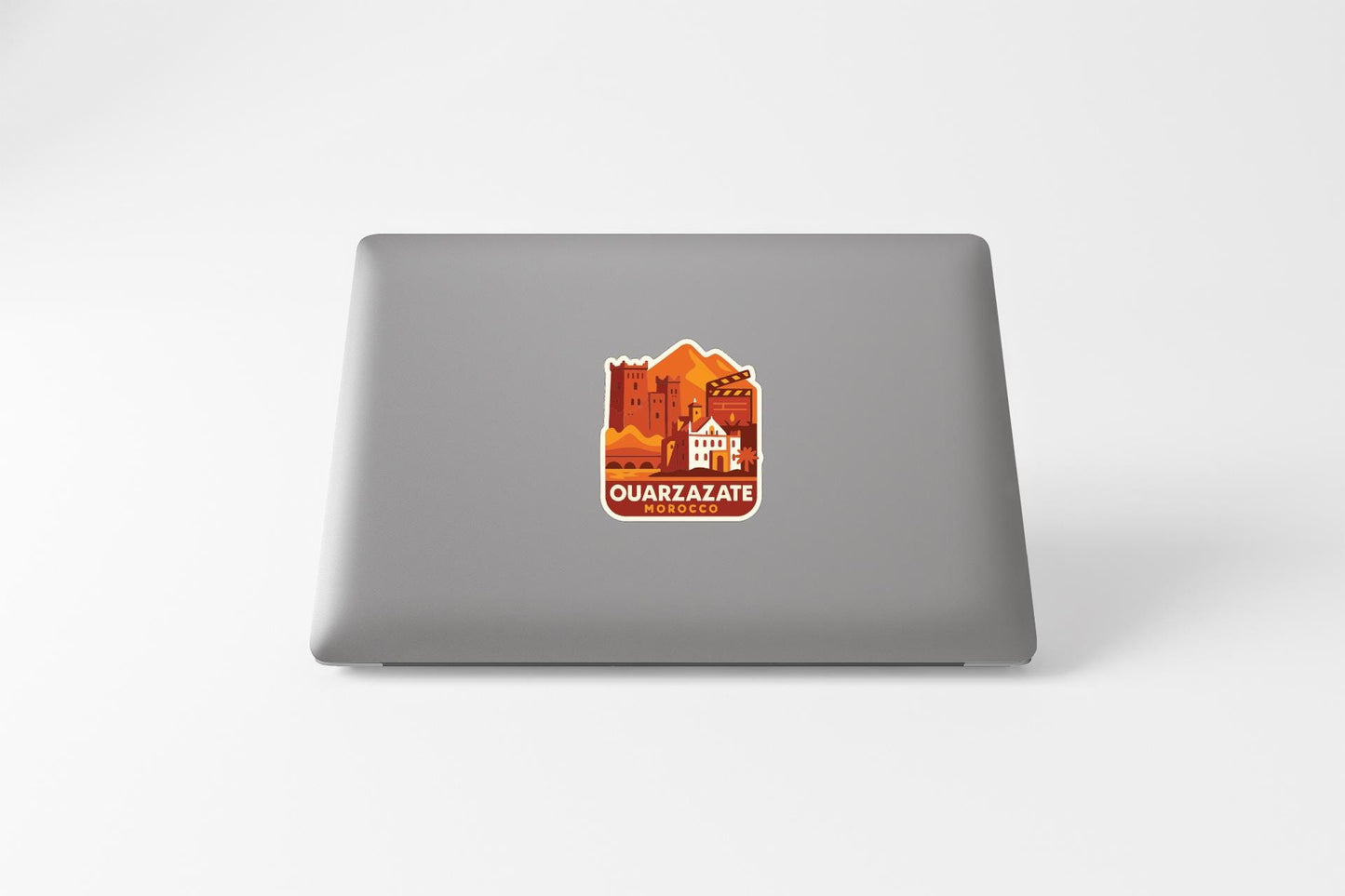 a sticker on the back of a laptop with an illustration of a cityscape and the text "QUARZAZATE" prominently displayed.