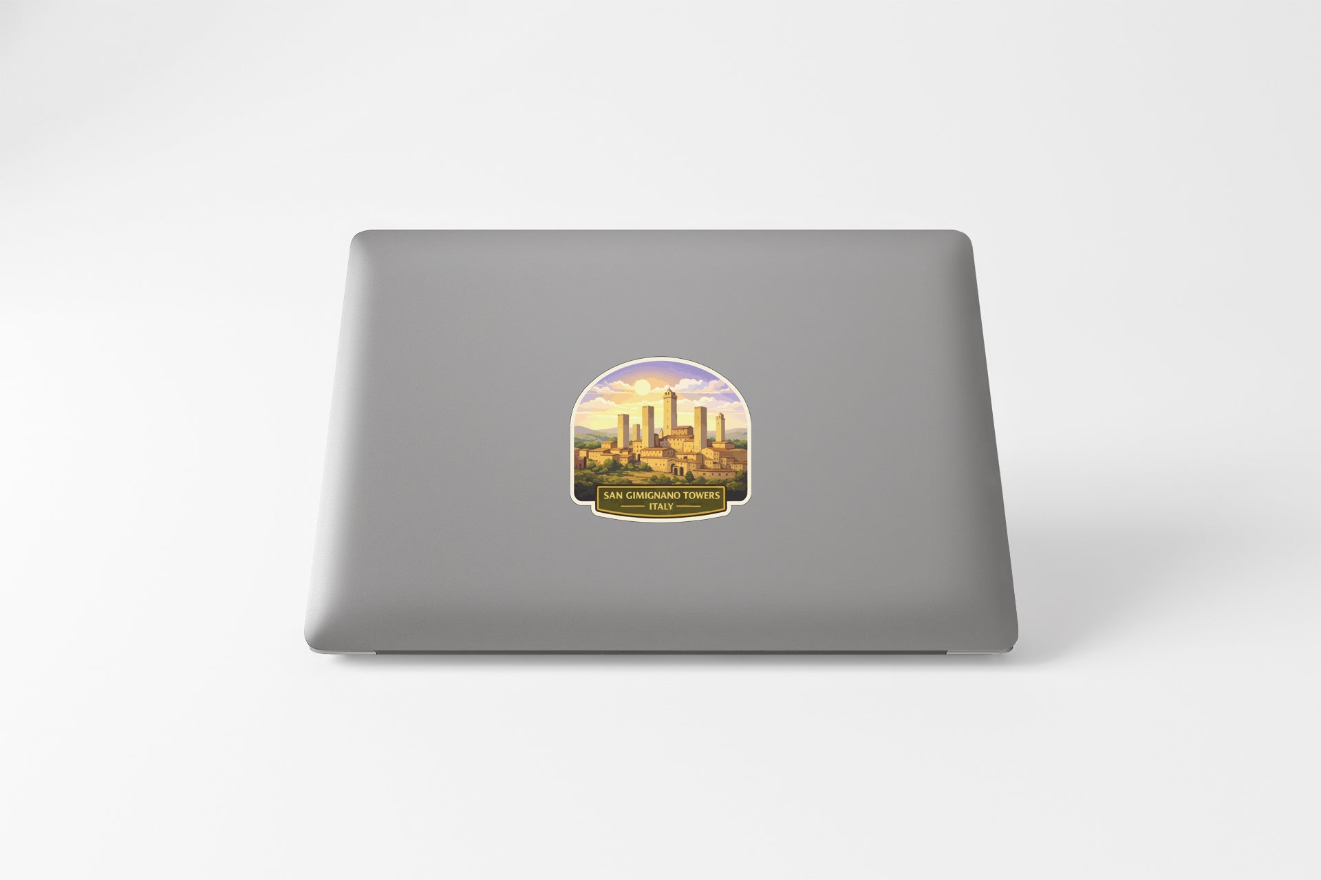 a sticker with a graphic of a cityscape on the back of a laptop.