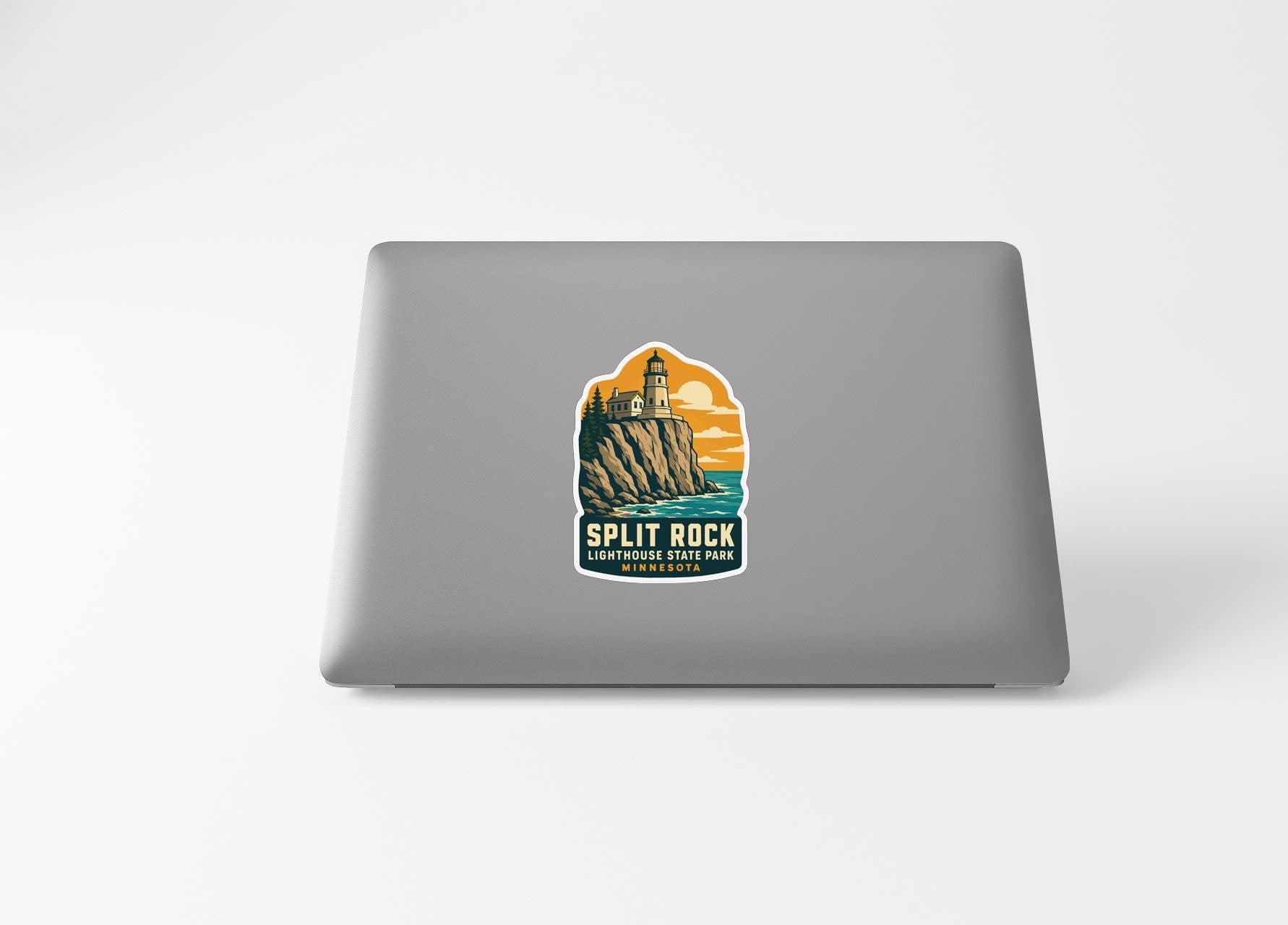a sticker with a lighthouse and a cliff, representing the Split Rock Lighthouse State Park.
