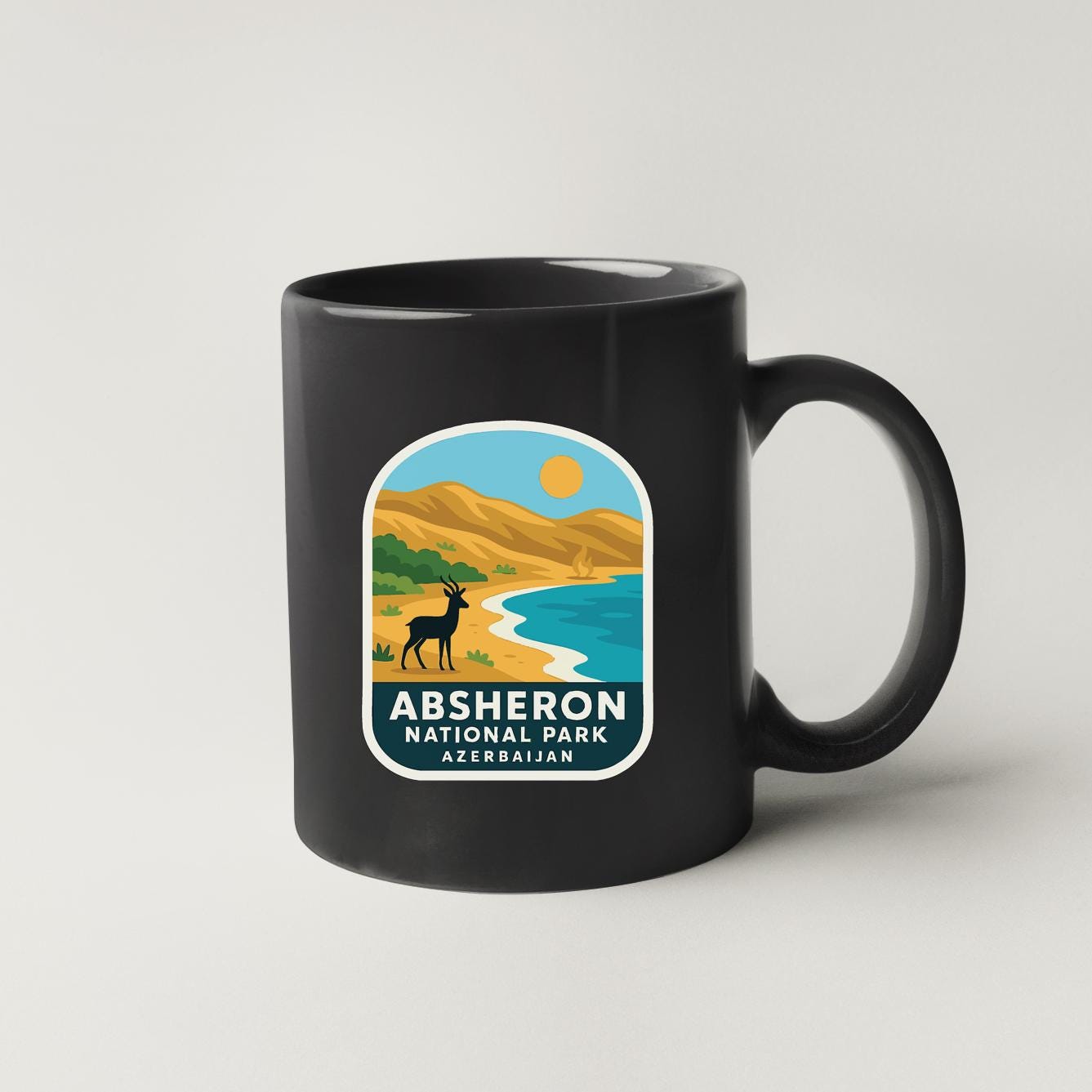 A black coffee mug with a label that says "ABSHERON NATIONAL PARK AZERBAJAN".