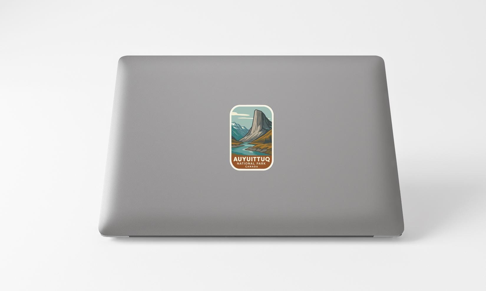 A sticker depicting a mountain landscape with the text "AUYUTUTU NATIONAL PARK" printed on it.