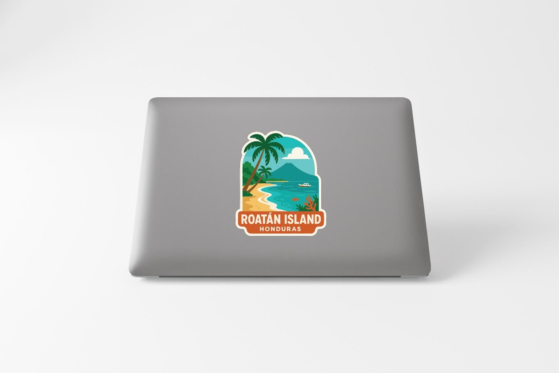 a sticker with a tropical beach scene and palm trees, along with the text "ROATAN ISLAND HONDURAS".
