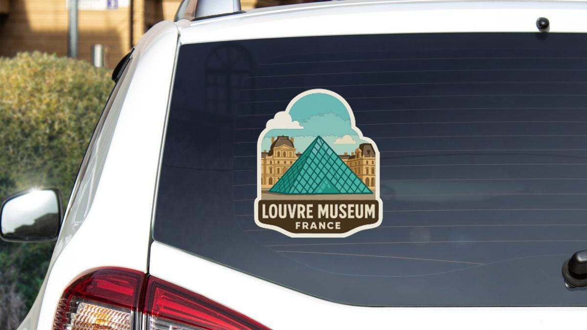 A sticker on the rear window of a car that says "LOUVRE MUSEUM FRANCE".