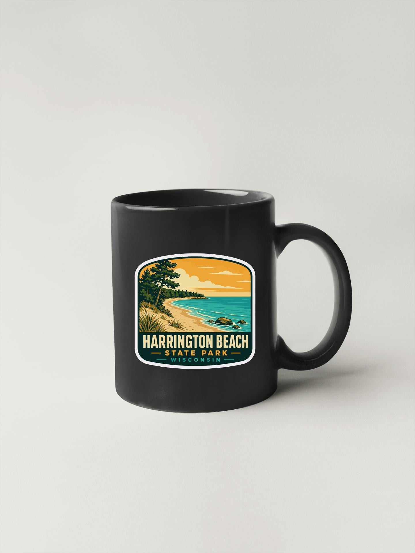 A black coffee mug with a graphic design depicting a beach scene with palm trees, a sunset, and a body of water.