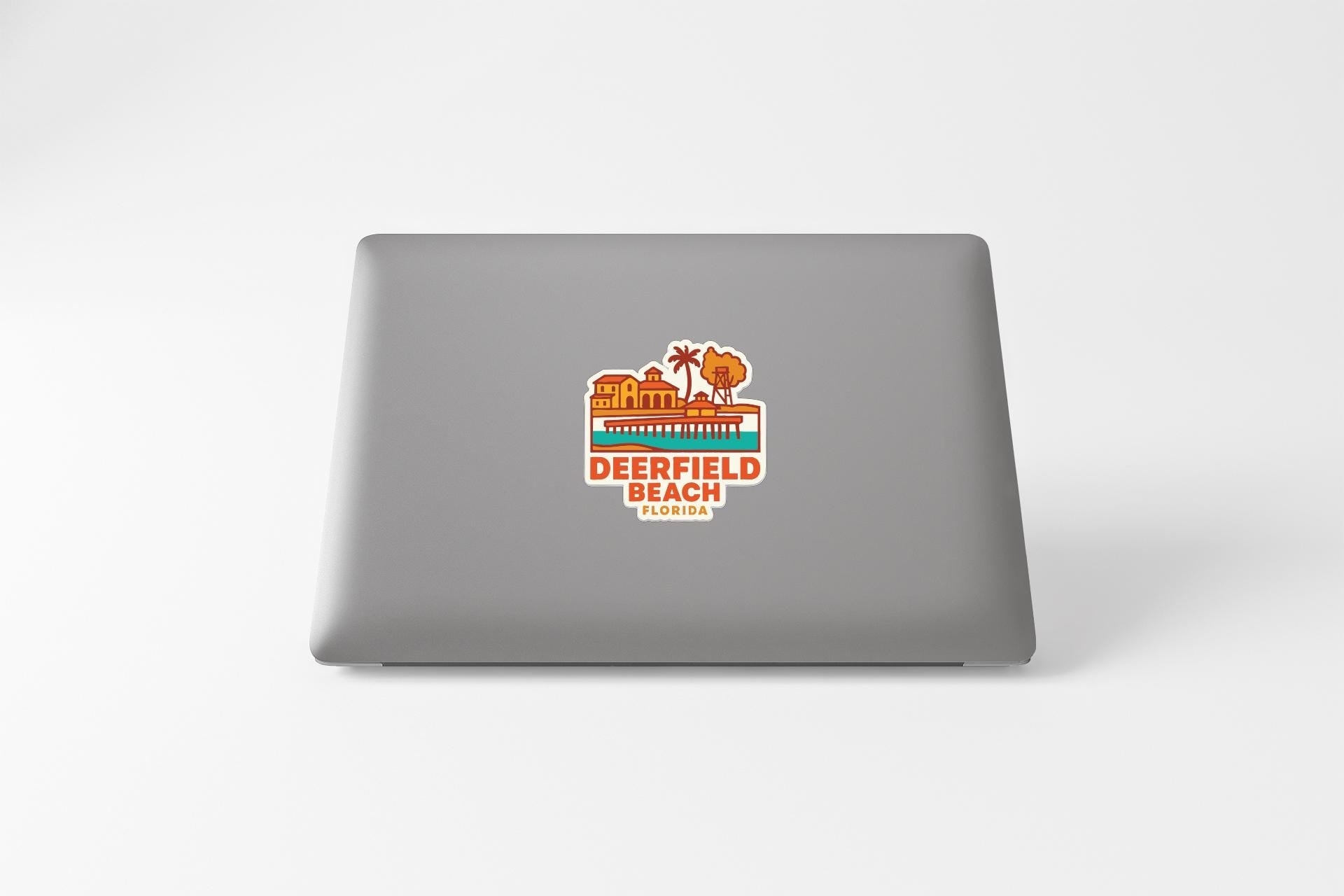 a sticker on the back of a laptop that says "DEERFIELD BEACH FLORIDA".