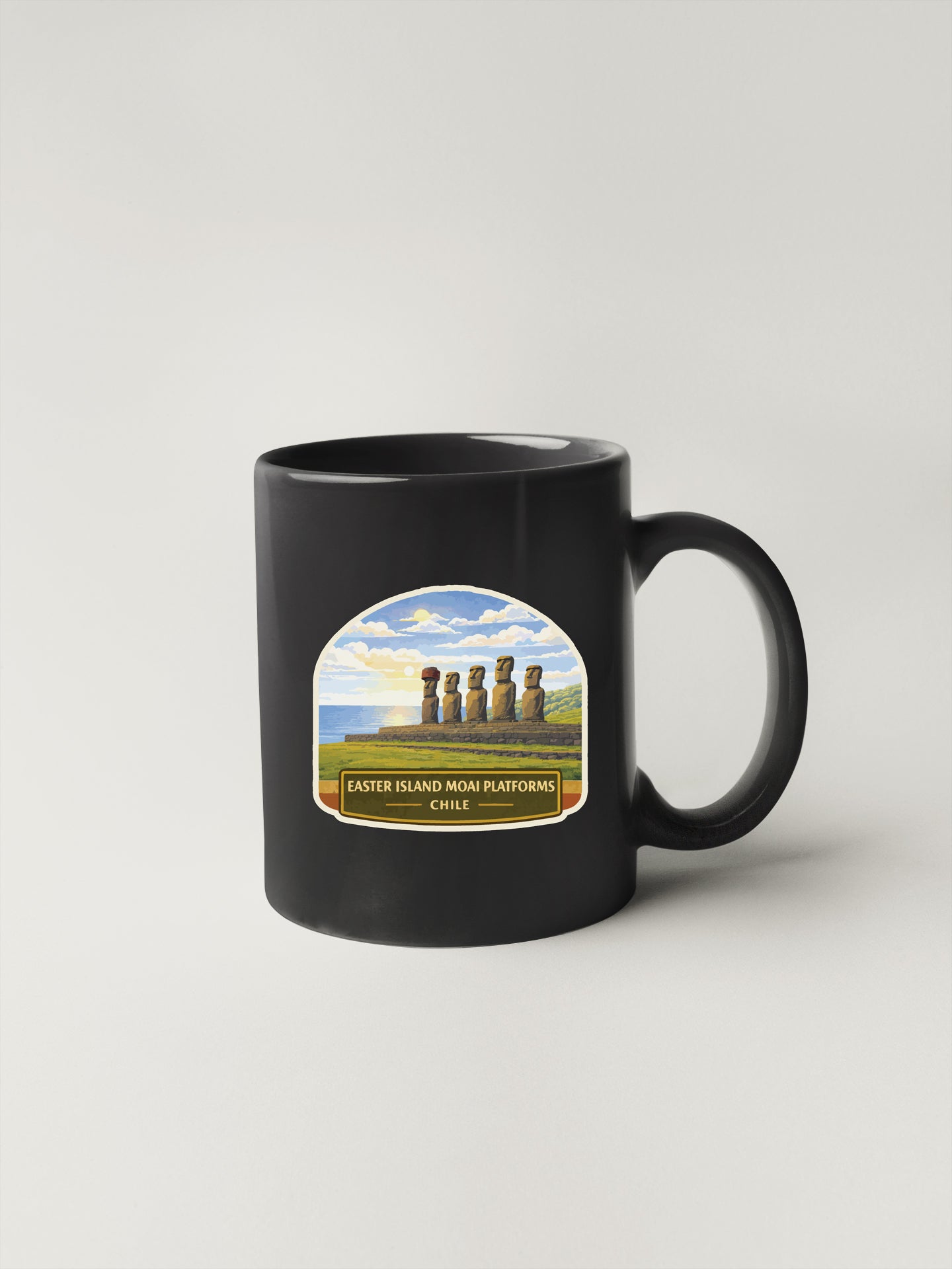 A black coffee mug with a label depicting Easter Island and the Easter Island Mom Platforms in Chile.