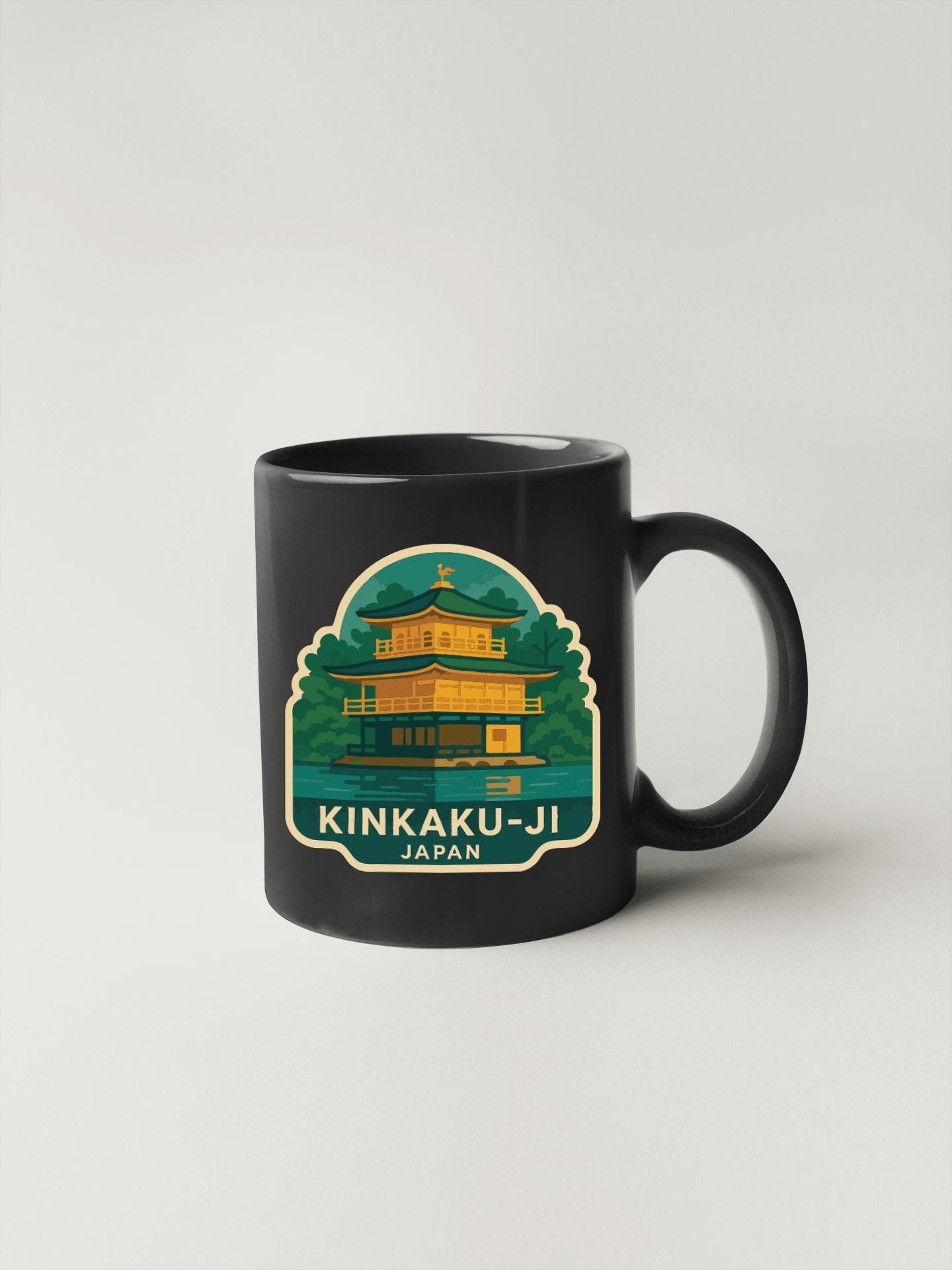 A black coffee mug with a sticker depicting the Kinkaku-ji temple in Japan.