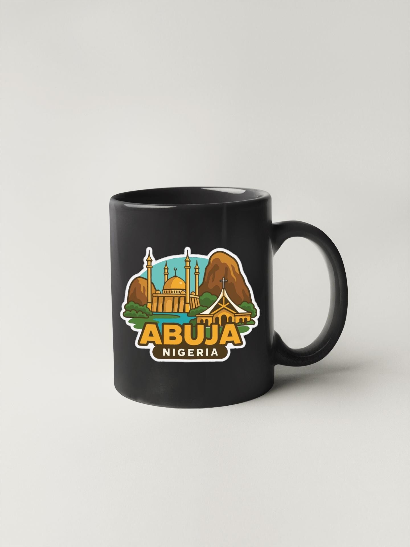 A black coffee mug with a graphic design depicting the skyline of Abuja, Nigeria.