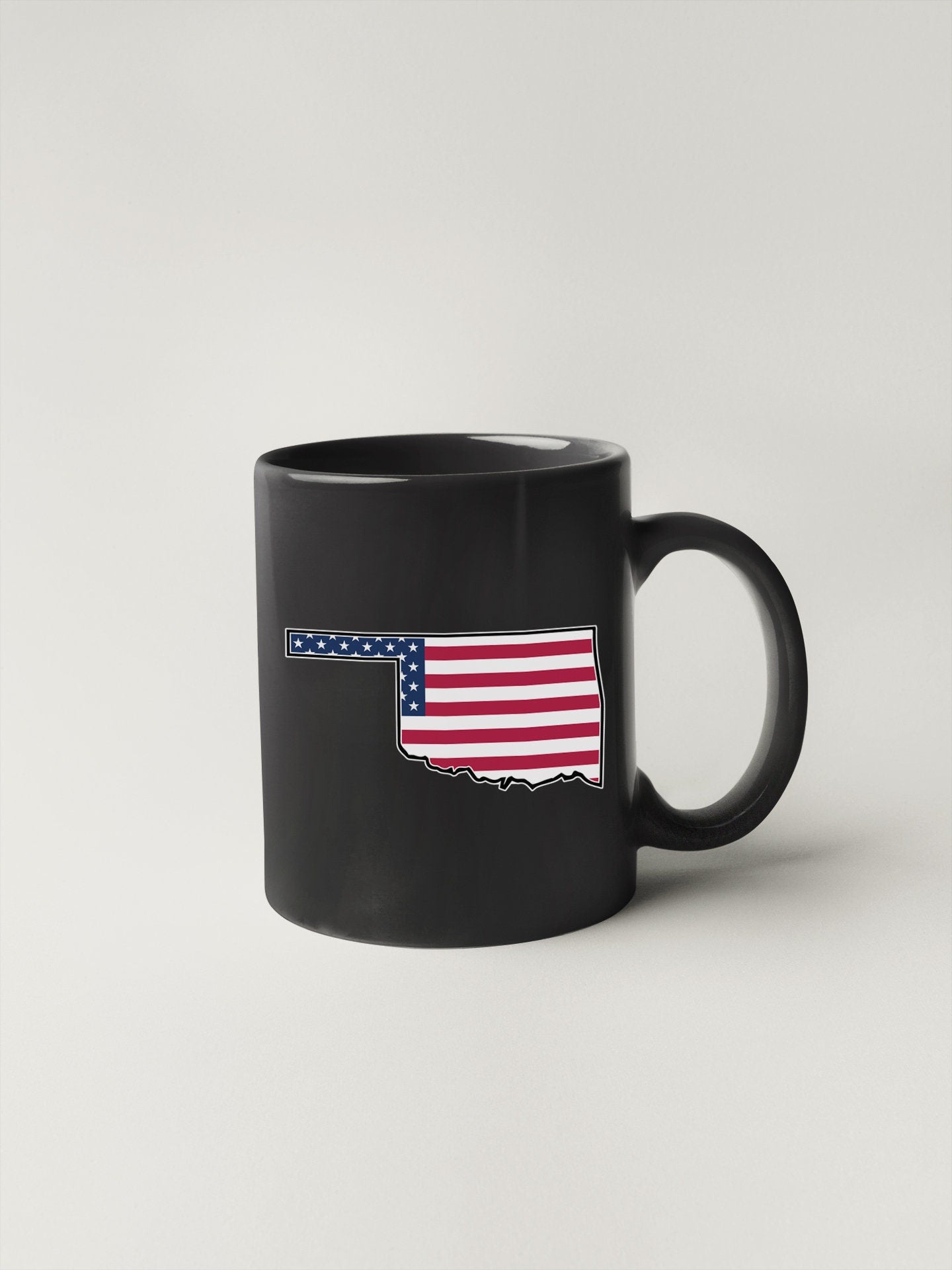 a black coffee mug with the american flag on it