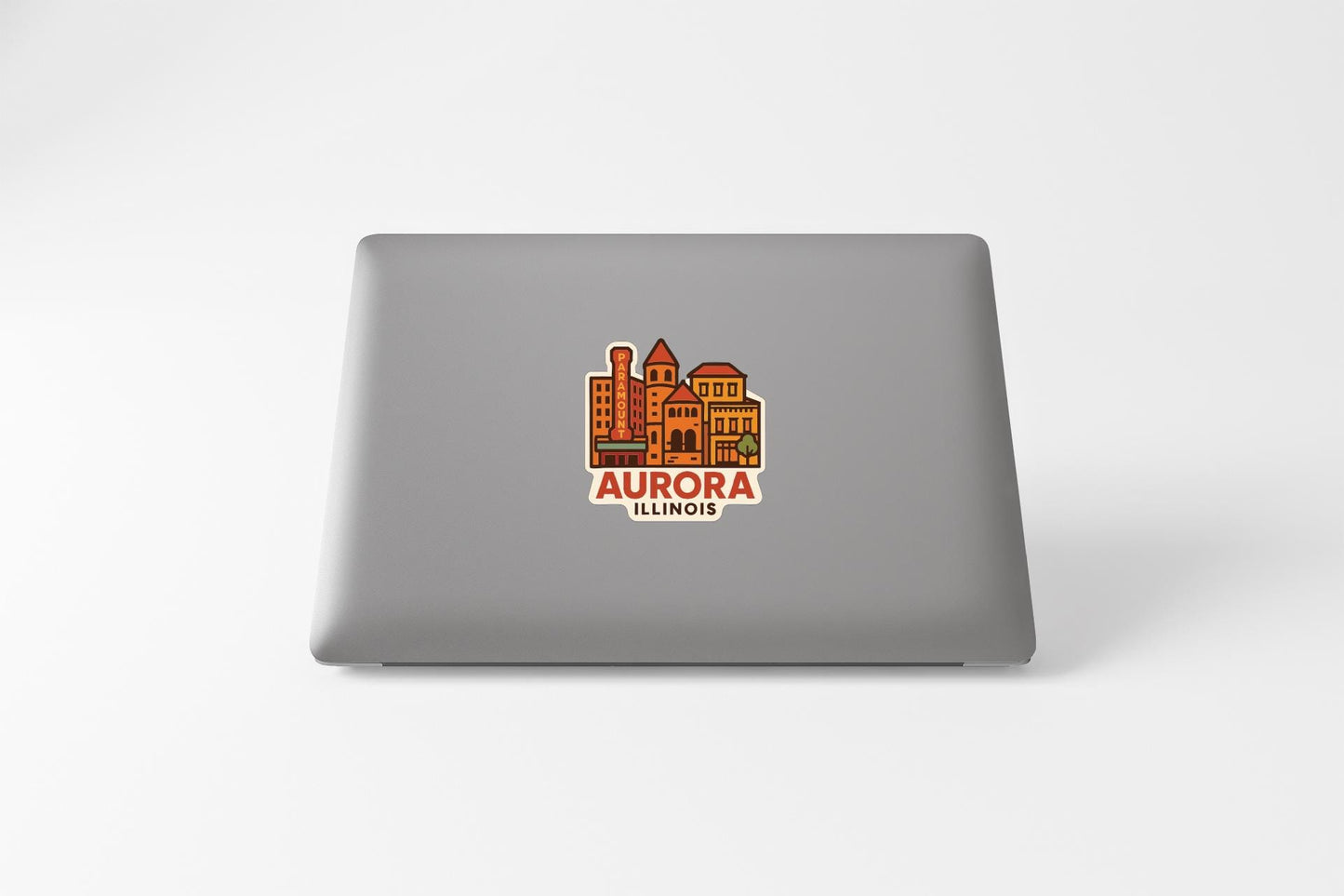 a sticker or decal of the city of Aurora, Illinois, on the back of a laptop.