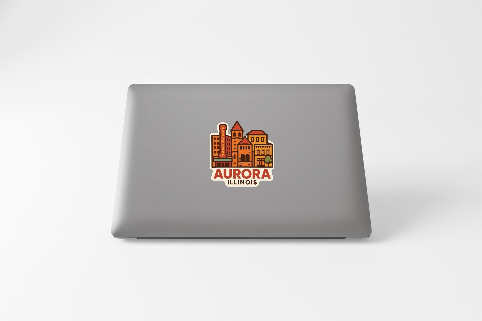 a sticker or decal of the city of Aurora, Illinois, on the back of a laptop.
