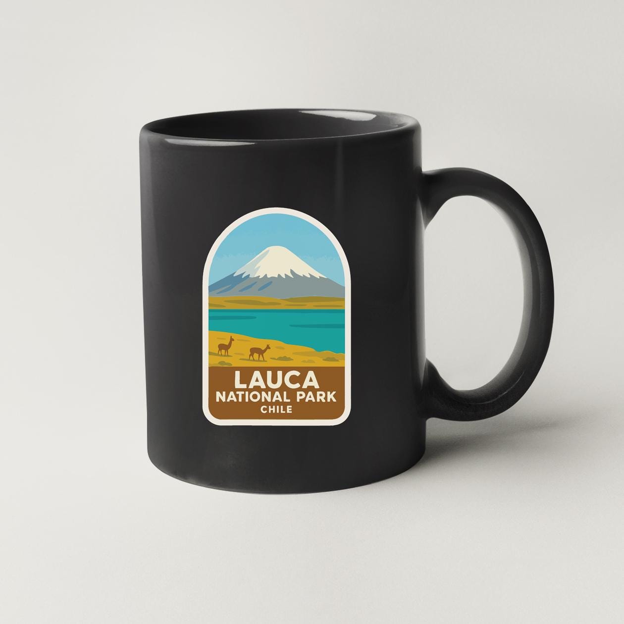 A black coffee mug with a label that says "LAUCA NATIONAL PARK CHILE".