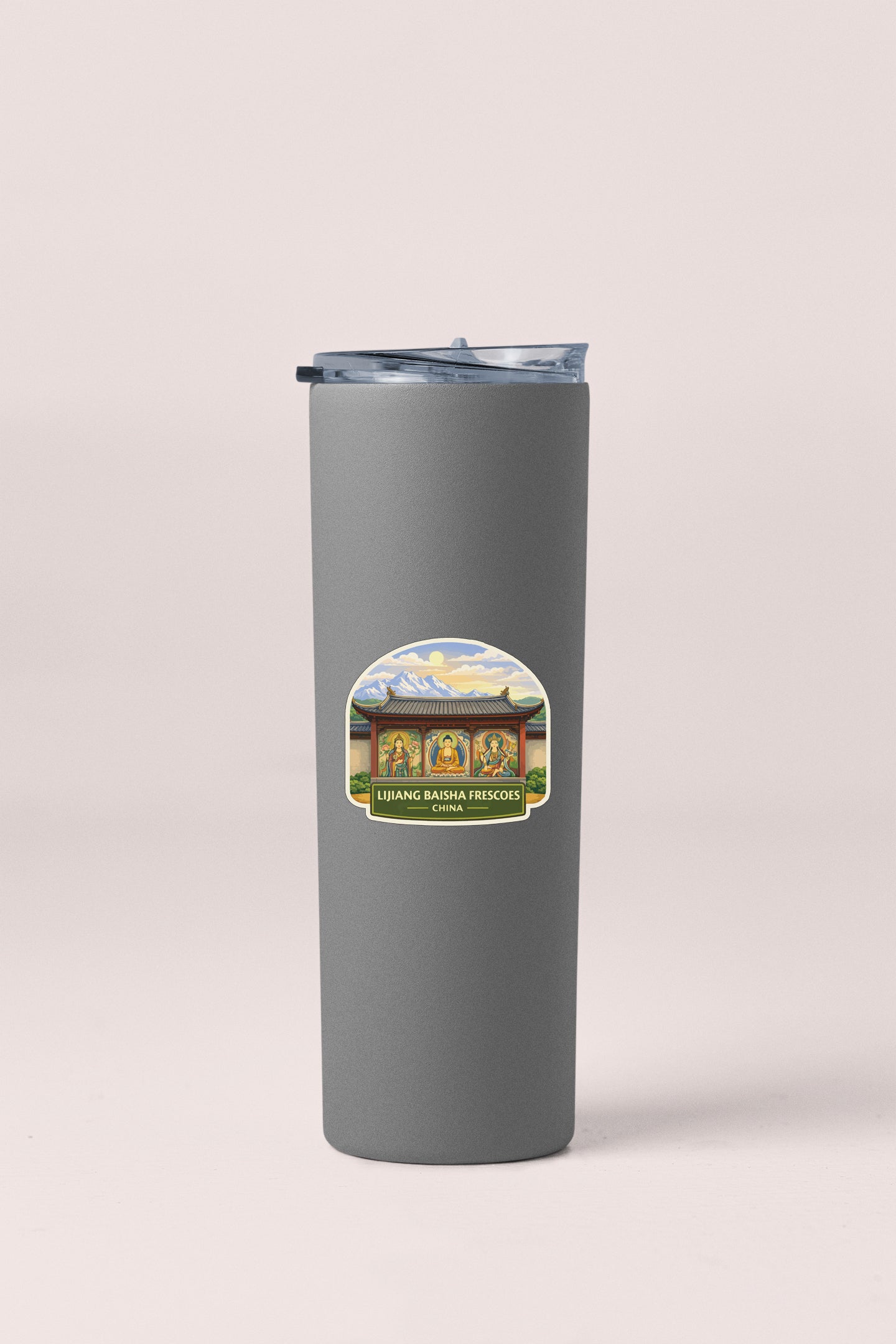 A gray insulated tumbler with a sticker depicting a scenic mountain landscape.
