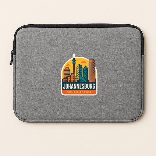 a gray laptop sleeve with a sticker of Johannesburg, South Africa, on it.