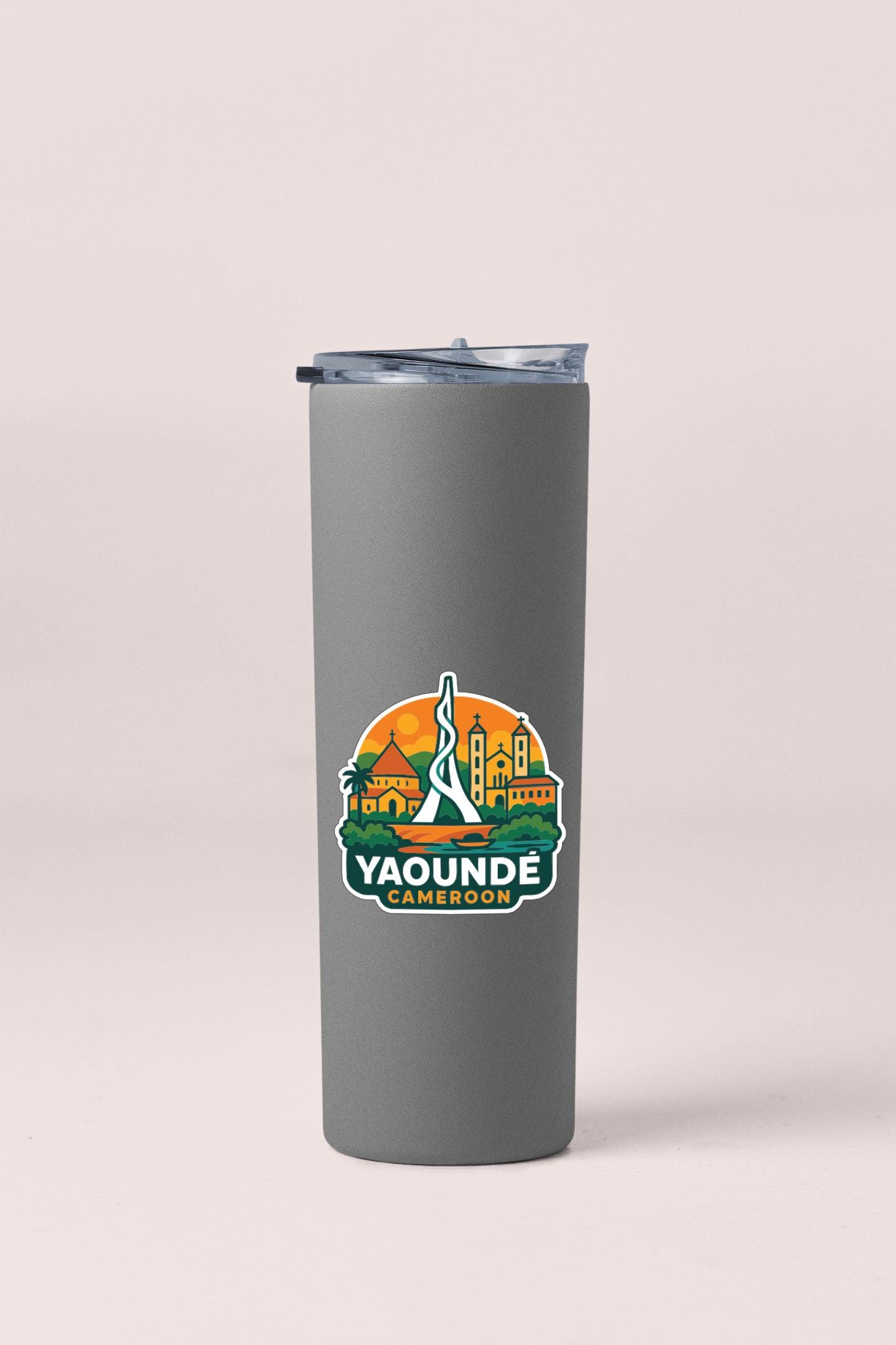 A gray tumbler with a logo that says "Yaounde Cameroon" on it.