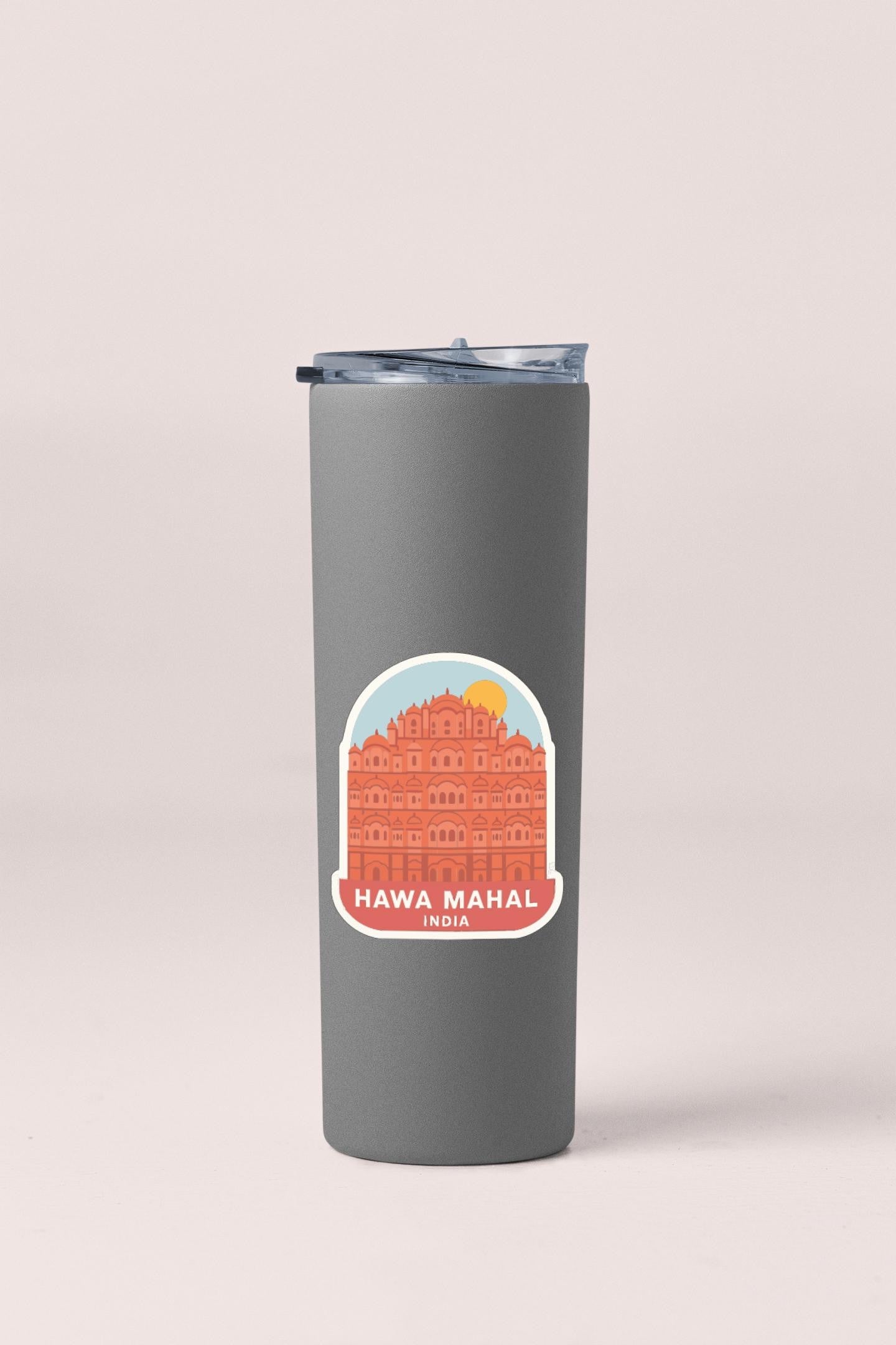 A gray insulated tumbler with a sticker depicting the Hawa Mahal, a famous landmark in India.