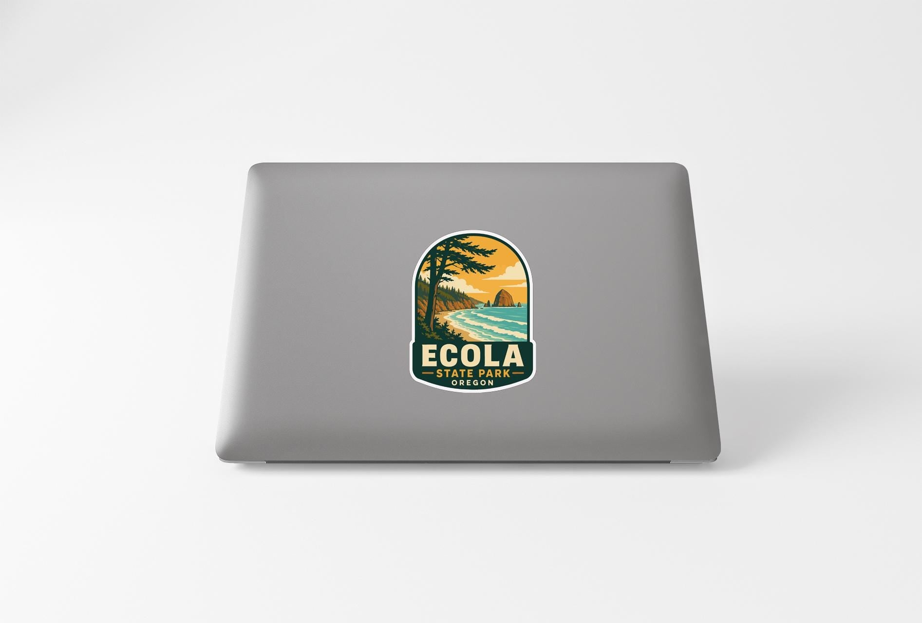 A sticker on the back of a laptop that says "ECOLA STREET PARK" and features a scenic landscape with a beach and palm trees.