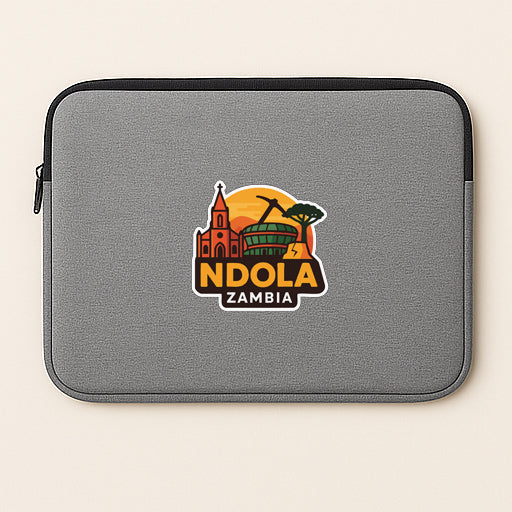 a gray laptop sleeve with a graphic design of a cityscape and the text "NDOLA ZAMBIA" printed on it.