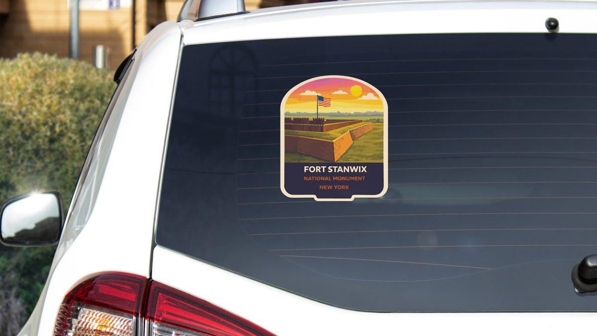 a sticker on the rear window of a white car, depicting Fort Stanwix National Monument in New York.