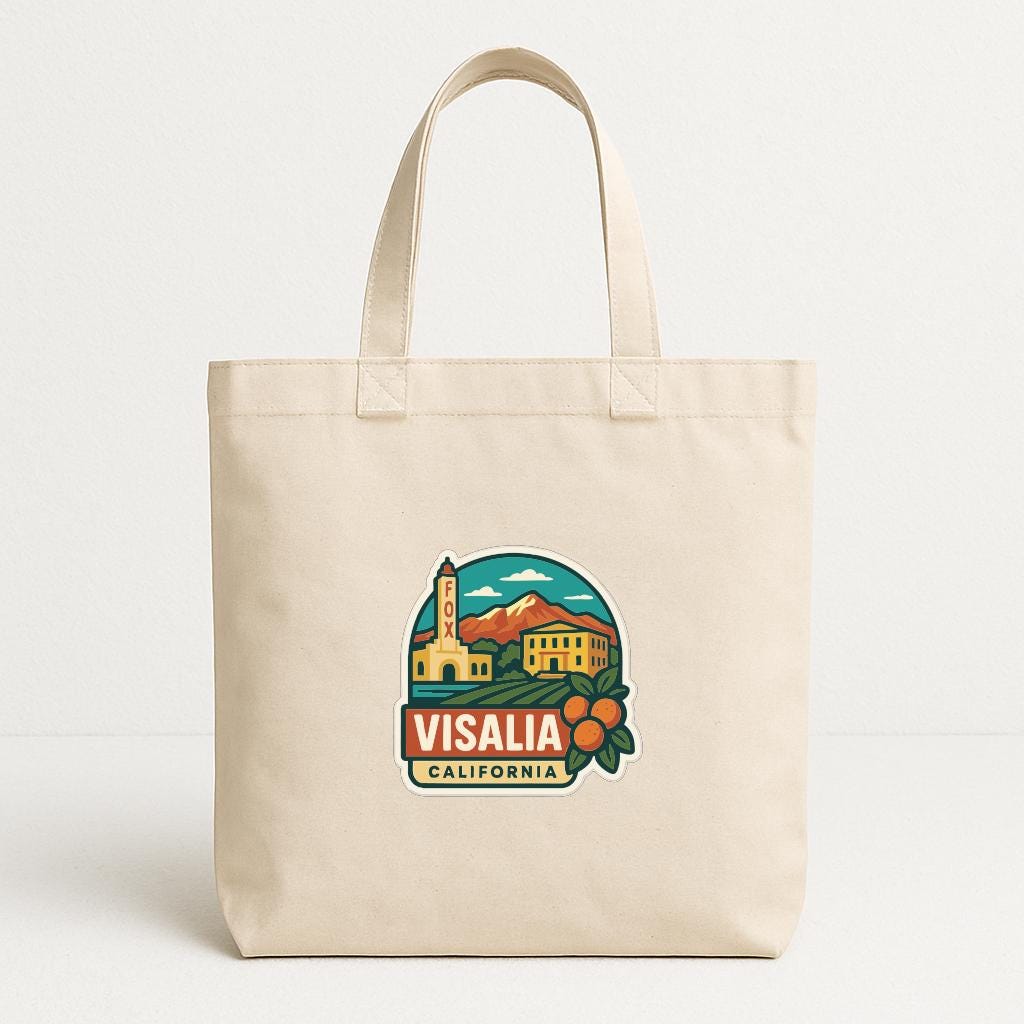 A beige tote bag with a printed design depicting a scenic view of Visalia, California.