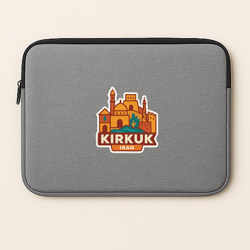 A gray laptop sleeve with a sticker depicting a cityscape and the text "KIRKUK Iraq".