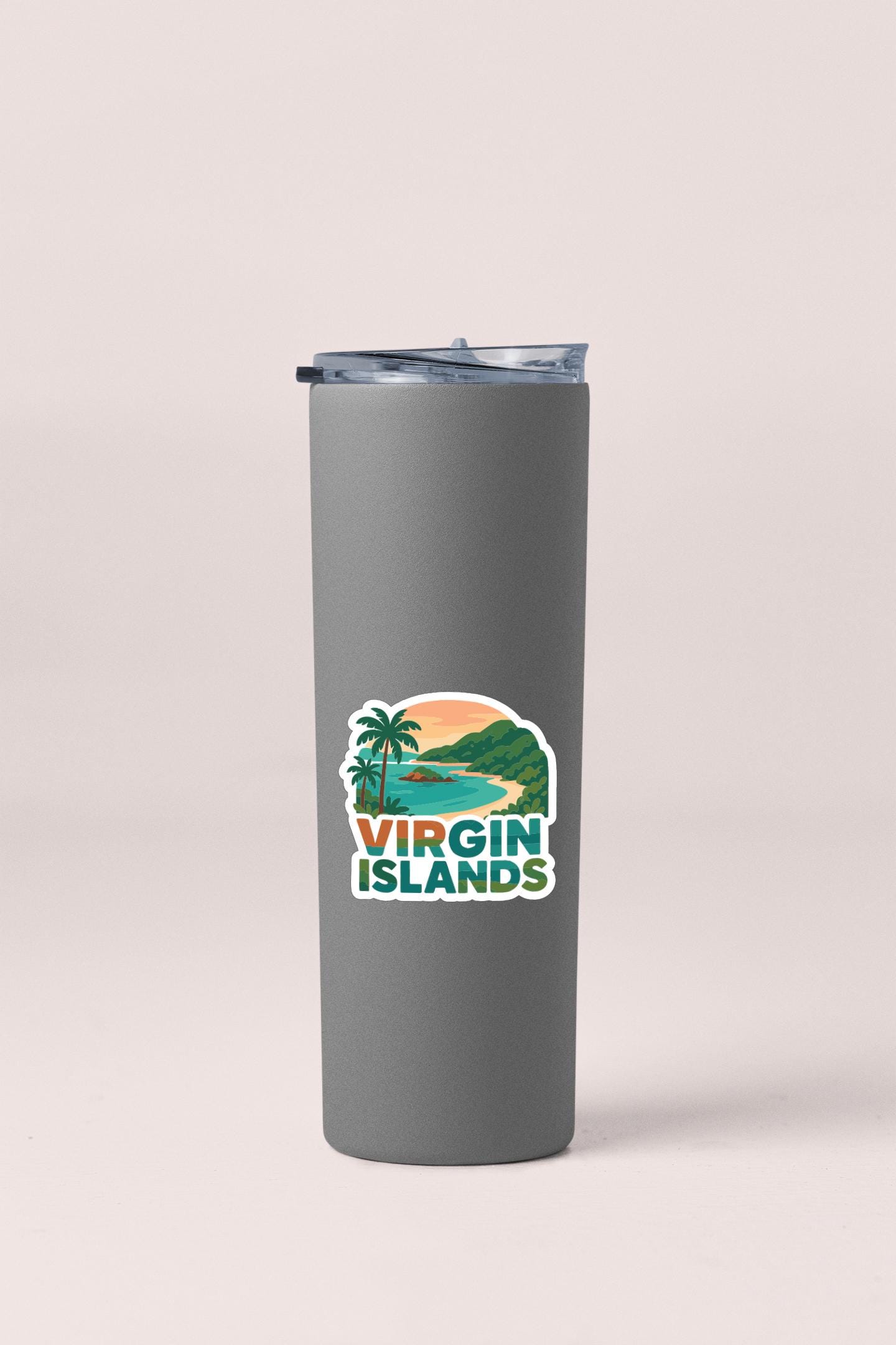 A gray insulated tumbler with a sticker depicting a tropical island landscape.