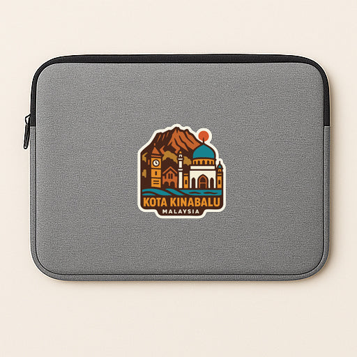 A gray laptop sleeve with a sticker depicting a cityscape and the text "KOTA KINABALU MALAYSIA".