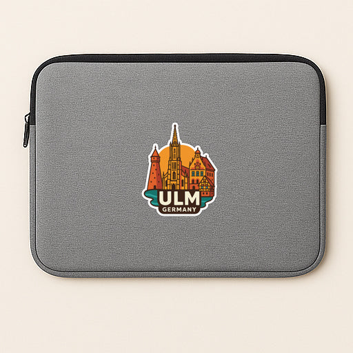 A gray laptop sleeve with a sticker of a city skyline and the text "ULM GERMANY" printed on it.