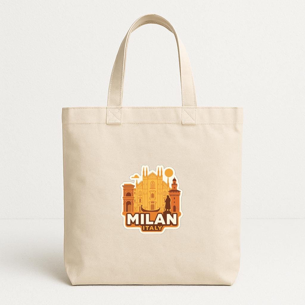 A beige tote bag with a graphic design featuring the silhouette of a city skyline and the text "MILAN ITALY" printed on it.
